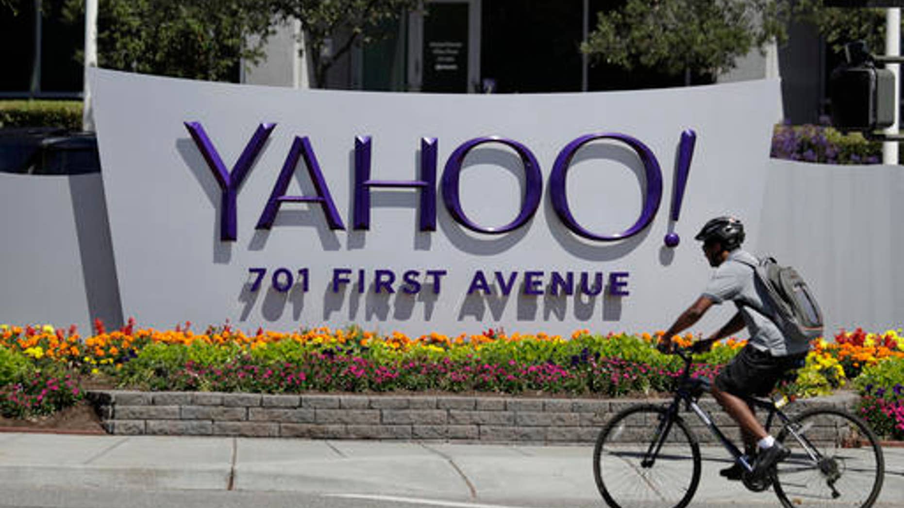 FILE - In this Tuesday, July 19, 2016 file photo, a cyclist rides past a Yahoo sign at the company's headquarters in Sunnyvale, Calif. (AP Photo/Marcio Jose Sanchez) (Copyright 2016 The Associated Press. All rights reserved.)