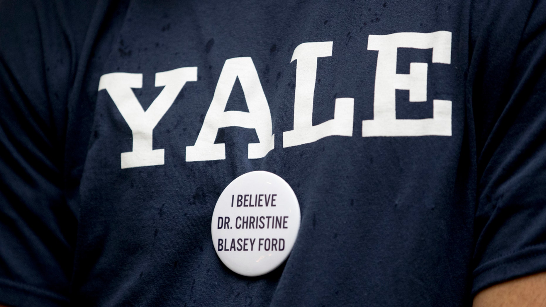 A protester against Judge Brett Kavanaugh wears a Yale shirt with a button that reads "I Believe Dr. Christine Blasey Ford, on Capitol Hill in Washington on Sept. 24.
