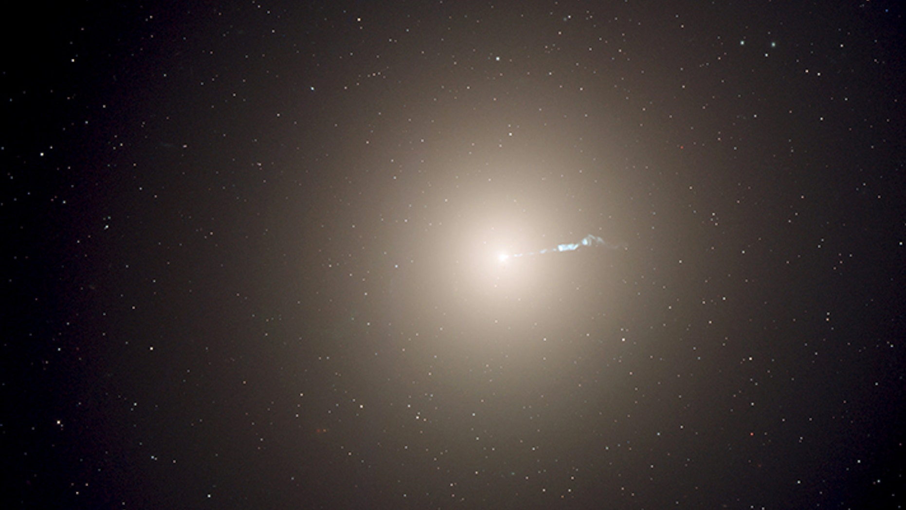 The monstrous elliptical galaxy M87, located 53 million light-years from Earth is the dominant galaxy at the center of the neighboring Virgo cluster of galaxies. Astronomers have measured the "heartbeats" of stars within M87 and used that data to determine the galaxy's age in a new way. This photograph was taken with the Hubble Space Telescope's Advanced Camera for Surveys instrument. (NASA, ESA, and the Hubble Heritage Team)