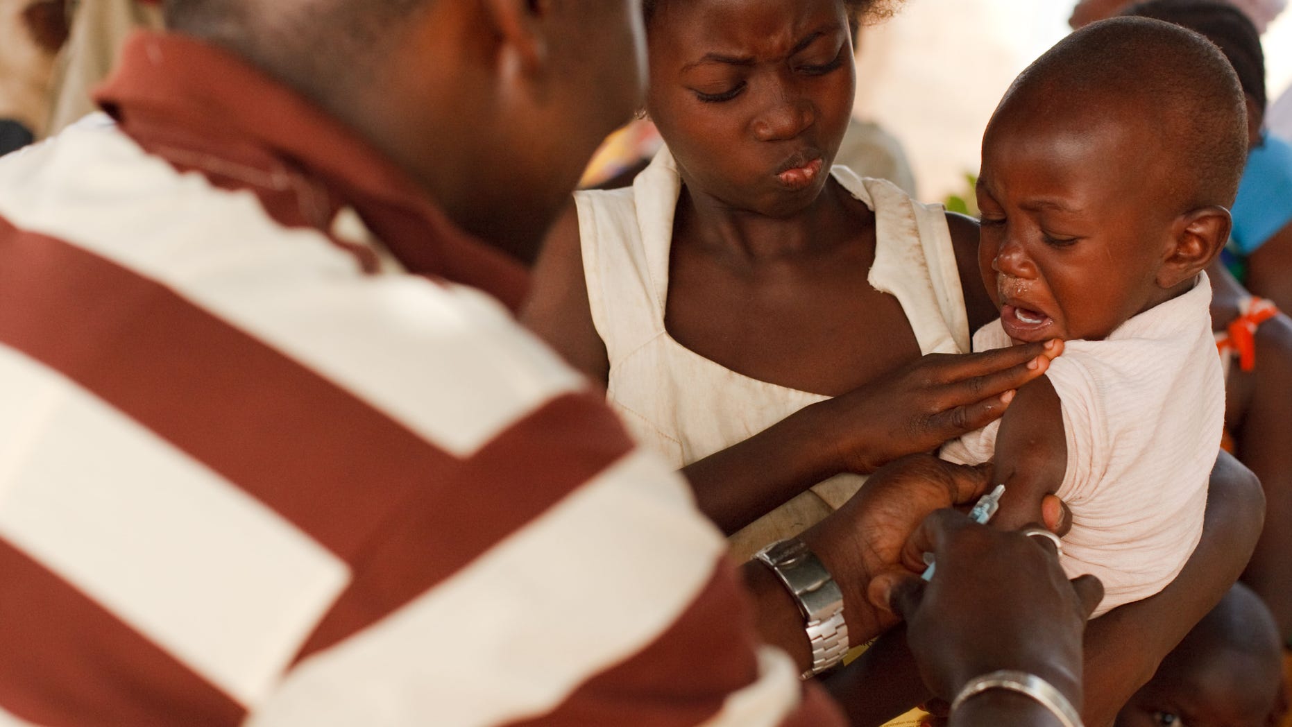 FILE- In this Saturday, Jan. 22, 2011 file photo, a health worker injects a young boy with yellow fever vaccine in Seguela in northern Ivory Coast. On Thursday, May 19, 2016 the UN health agency convened an expert committee to consider whether the epidemic of yellow fever, an acute viral hemorrhagic fever, qualifies as an international public health emergency. (AP Photo/Olivier Asselin, File)