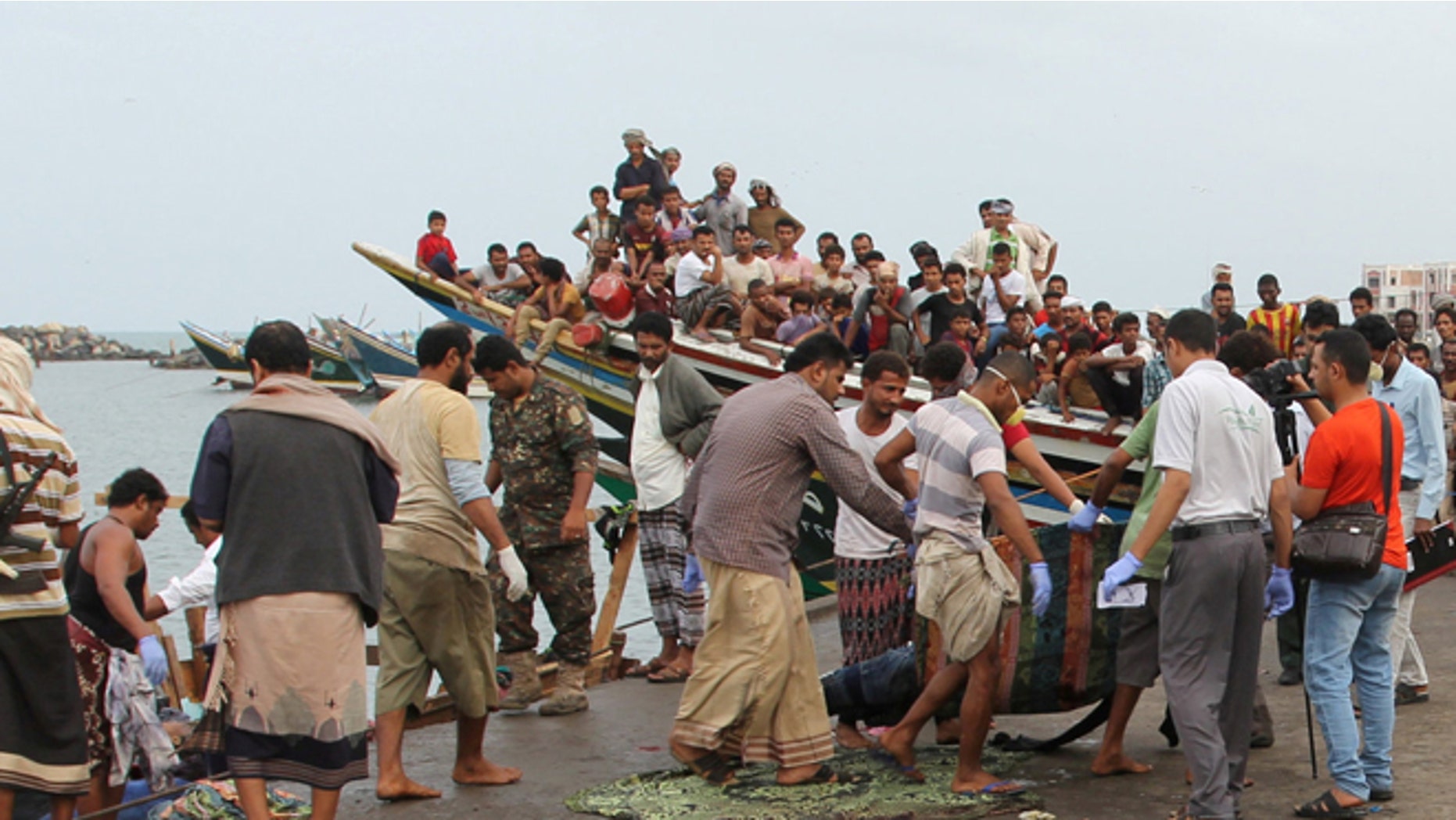 Body of a Somali refugee, killed in an attack by a helicopter while travelling in a vessel off Yemen, is carried at the Red Sea port of Hodeidah, Yemen, Friday.