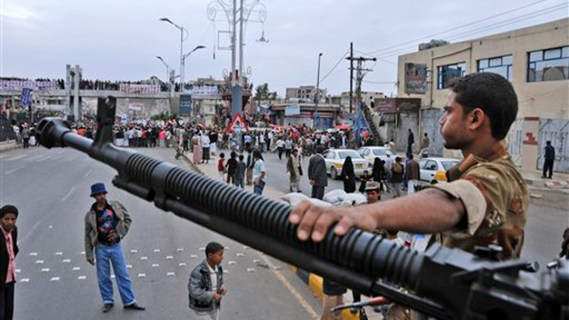 May 25: A Yemeni army soldier stands guard at a checkpoint in Sanaa, Yemen. Yemen's embattled President Ali Abdullah Saleh issued messages of hard-line defiance Wednesday even as intense battles raged in the heart of the capital for a third day, saying he will not step down or allow the country to become a "failed state." (AP)