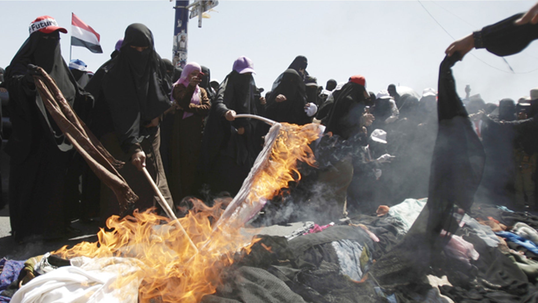 Oct. 26, 2011: Protesting Yemeni women burn their veils during a demonstration demanding the resignation of Yemeni President Ali Abdullah Saleh in Sanaa, Yemen.