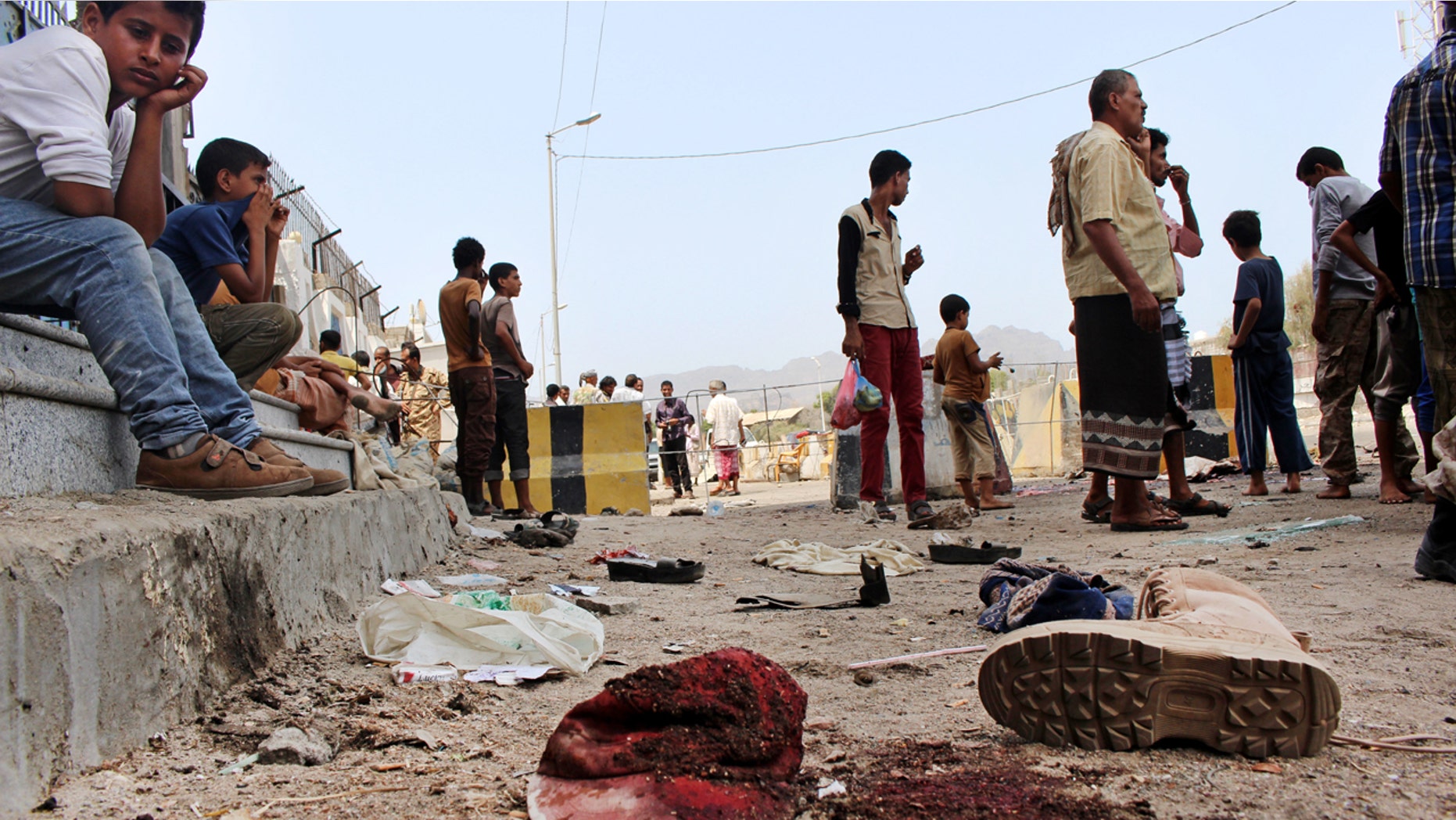 May 23, 2016: People gather at the scene after a pair of suicide bombings attack in the southern city of Aden, Yemen.