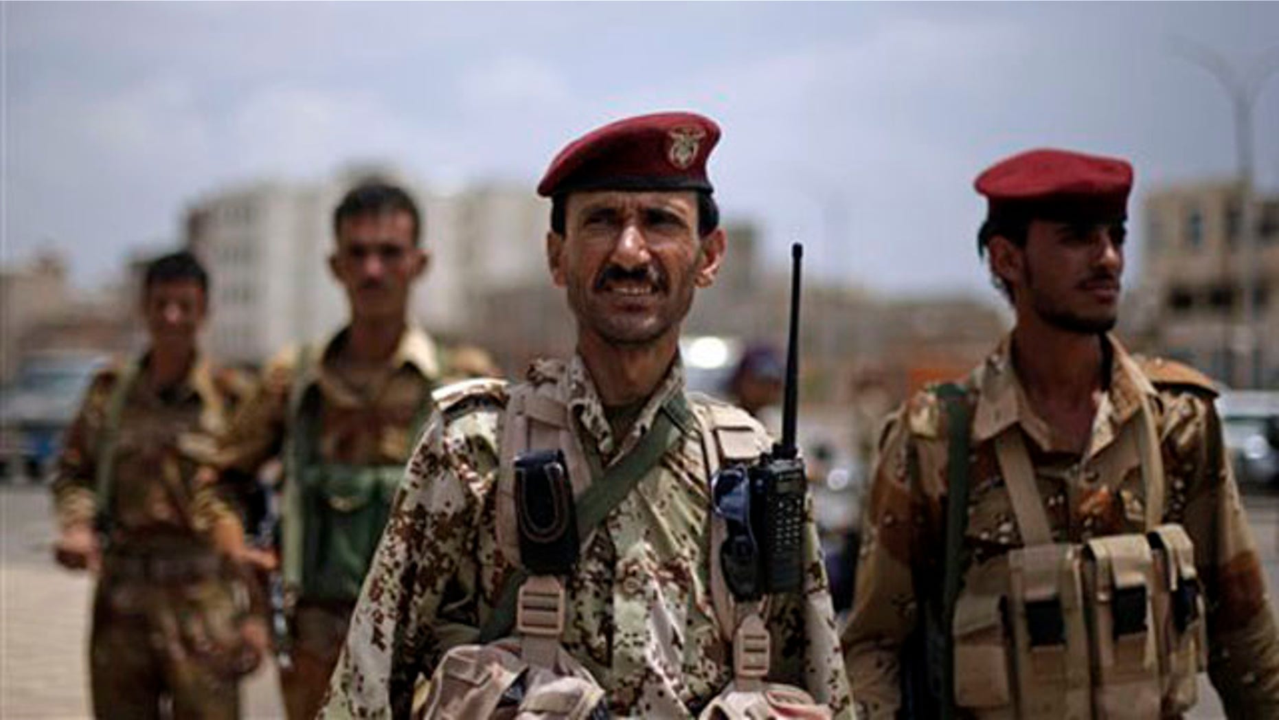 A Yemeni soldier who defected looks on as he stands guard with others at a checkpoint next to the site of a demonstration by anti-government protestors demanding the resignation of Ali Abdullah Saleh in Sanaa, Yemen, Thursday, Sept. 8, 2011.