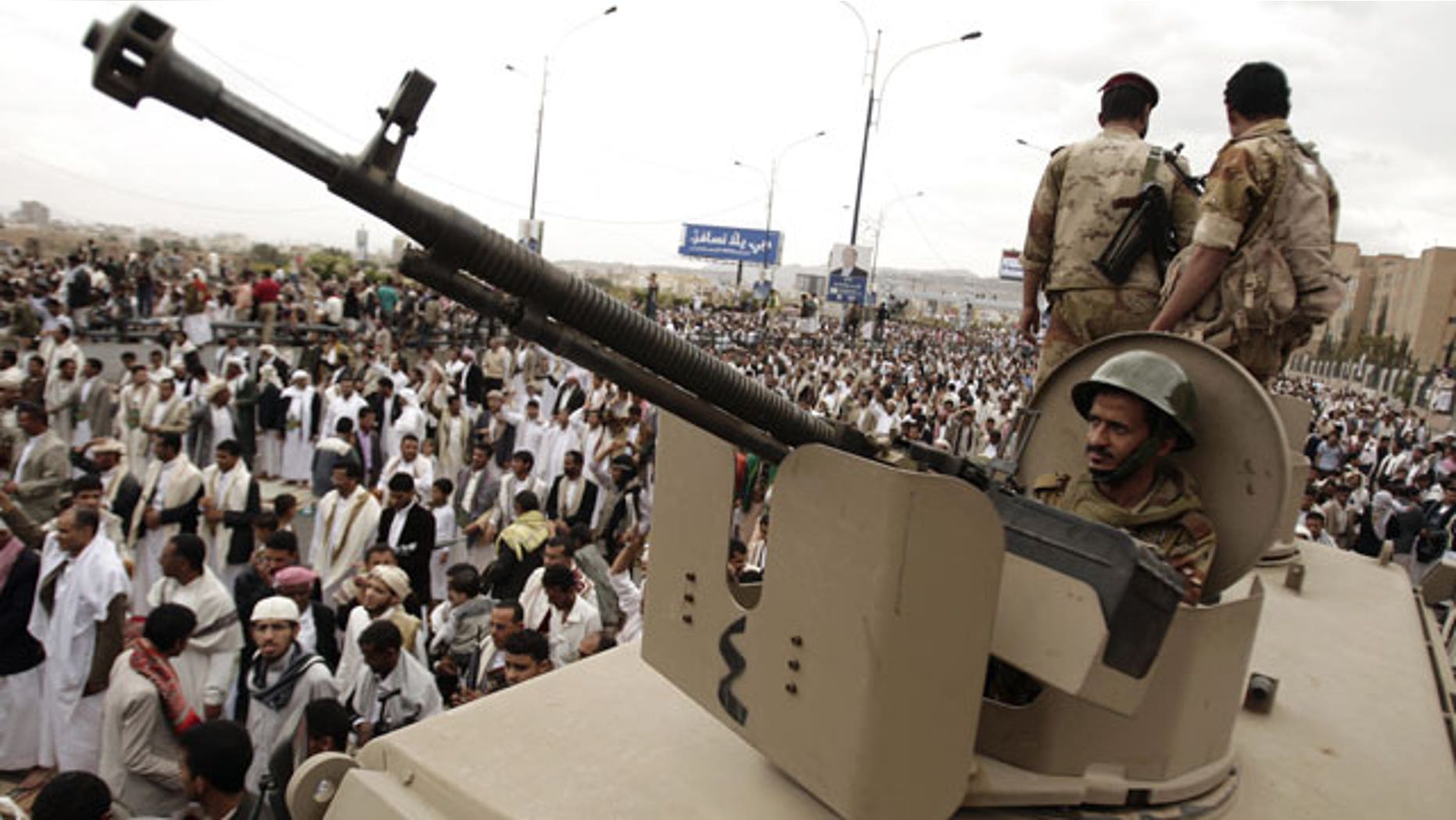 Mar. 30, 2012: A defected army soldier supporting protestors looks on from behind a weapon mounted on a patrol truck to secure a street where protestors demand the trial of Yemen's former President Ali Abdullah Saleh, in Sanaa, Yemen.