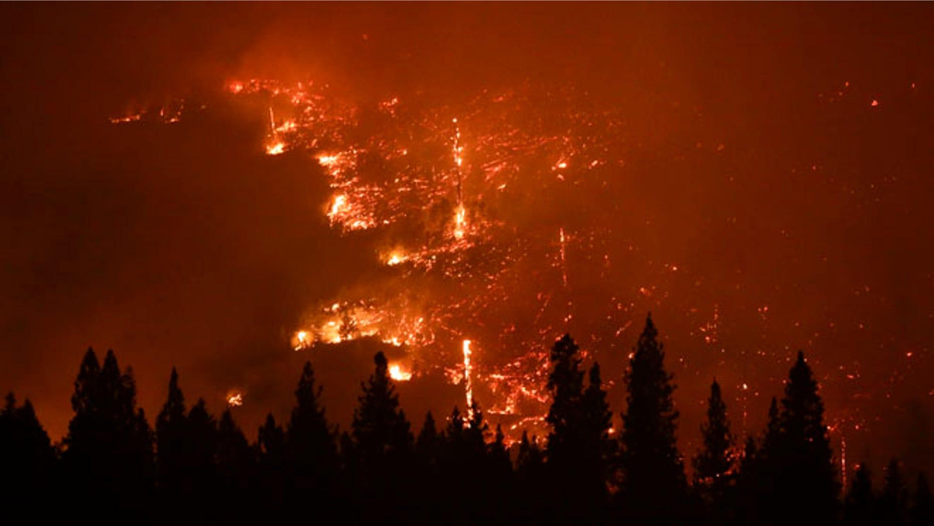 Aug. 24, 2013: A forest smolders as the Rim Fire continues to burn near Yosemite National Park, Calif. Keith Matthew Emerald was charged Thursday, Aug. 7, 2014 with starting the state's third-largest wildfire.