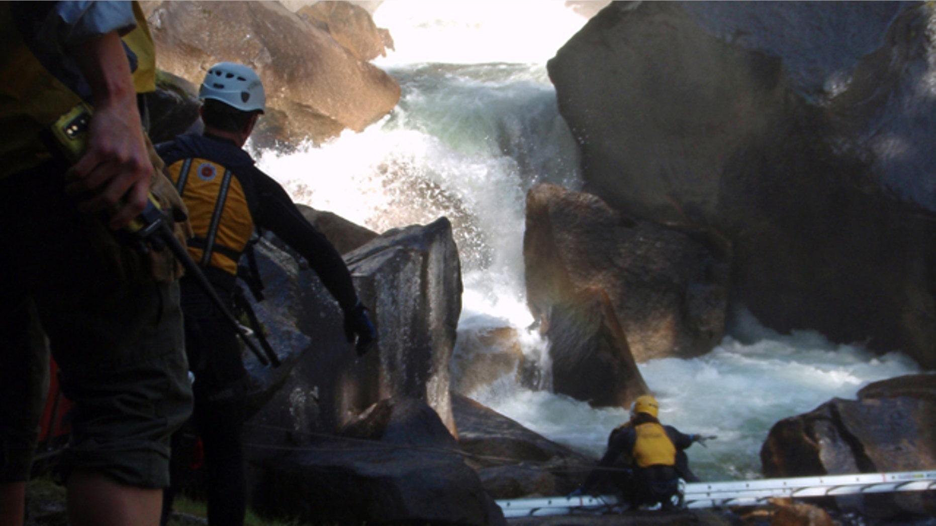 FILE - In this undated file photo provided by the National Park Service, authorities look to recover the bodies of three members of a church group who were swept into a raging waterfall at Yosemite National Park in California.