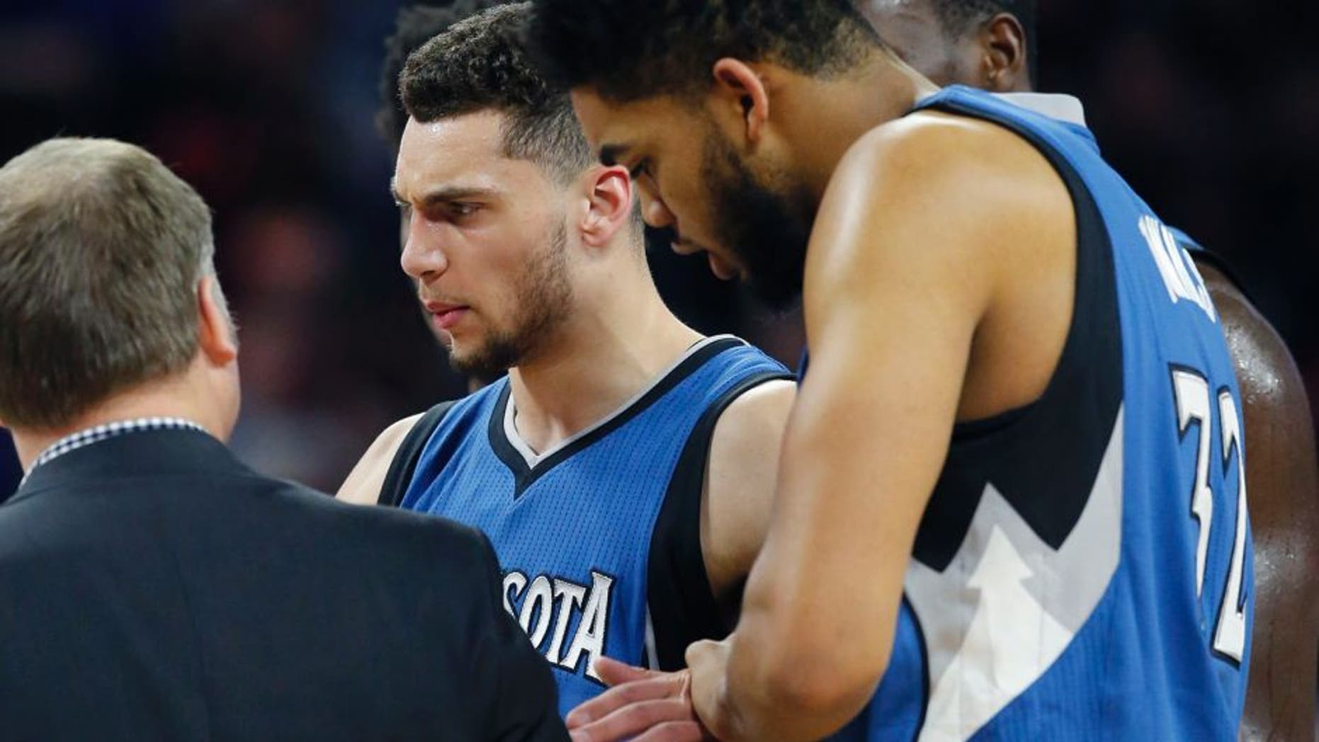 Minnesota Timberwolves guard Zach LaVine is helped off the court during the second half of the team's NBA basketball game against the Detroit Pistons, Friday, Feb. 3, 2017, in Auburn Hills, Mich. (AP Photo/Carlos Osorio)