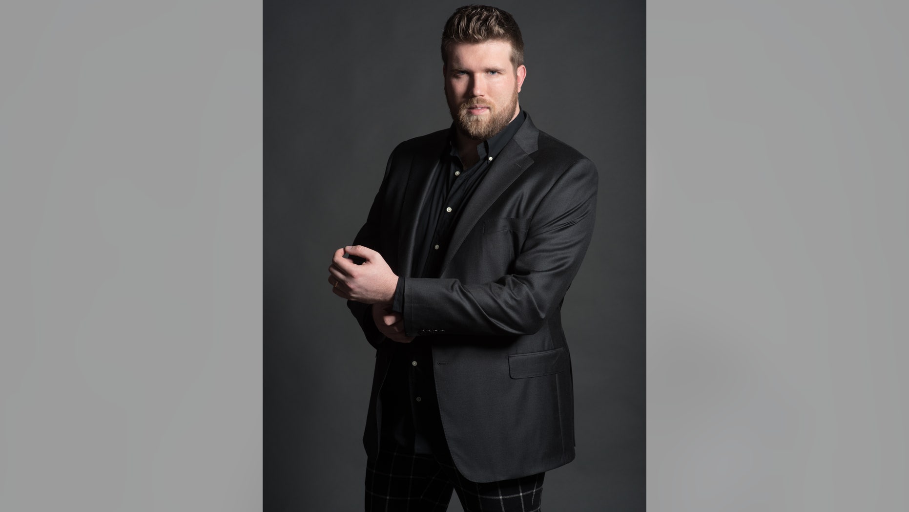 Plus-size male model Zach Miko poses.