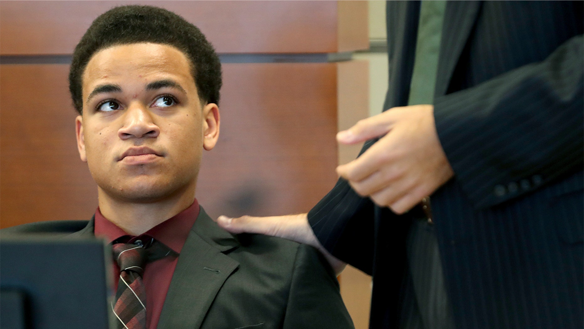 Zachary Cruz, left, seen during a hearing at the Broward County Courthouse in Fort Lauderdale, Fla., on May 11, told the Miami Herald that his brother Nikolas Cruz threatened both he and their mother with a gun on separate occasions.