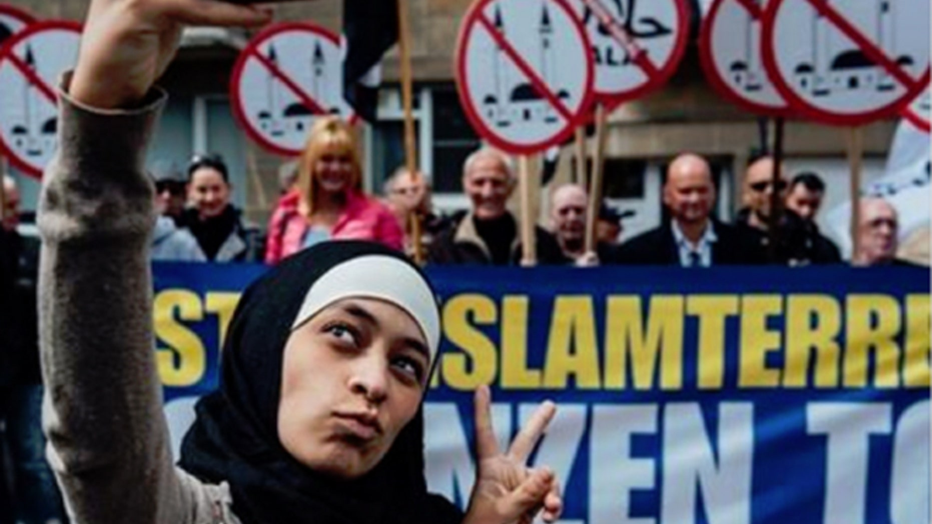 Pictures of her taking a peace sign selfie in front of protesters made Zakia Belkhiri a media darling - briefly.