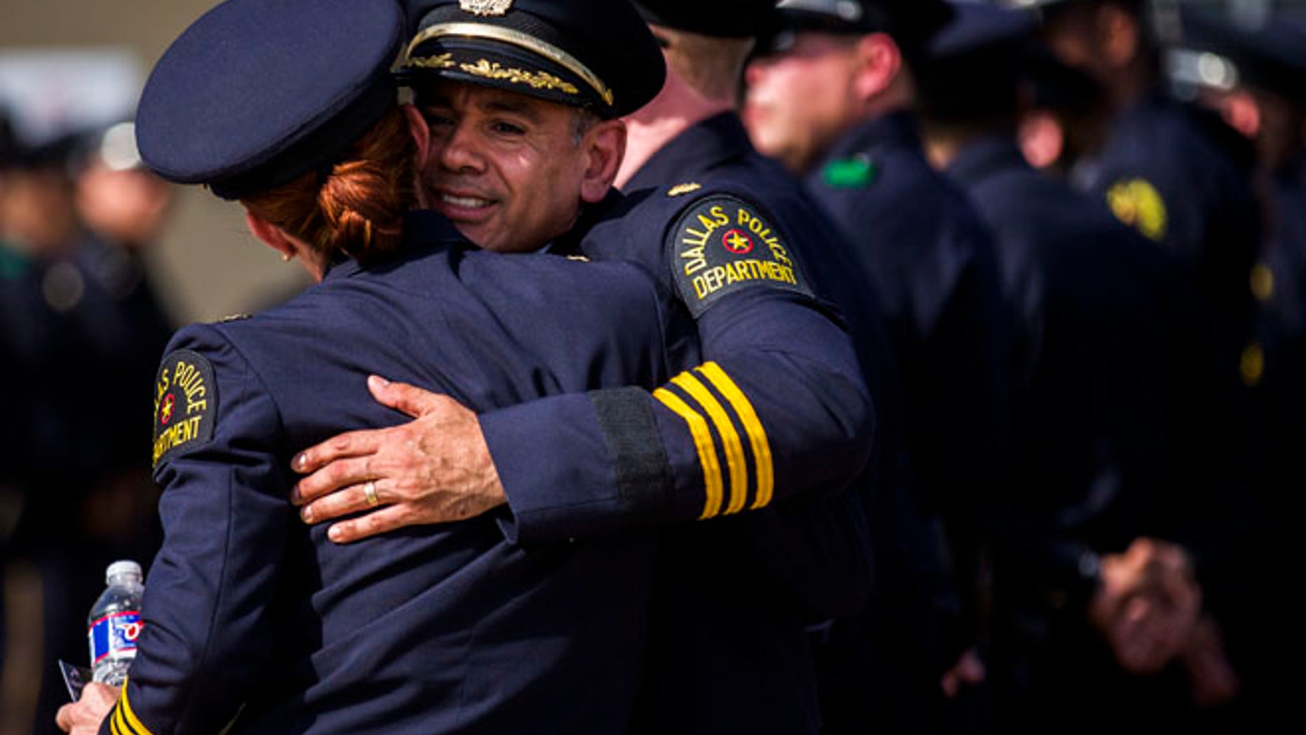 Police officers greet each other before a funeral service for Dallas police officer Patrick Zamarripa on Saturday, July 16, 2016, in Fort Worth, Texas.