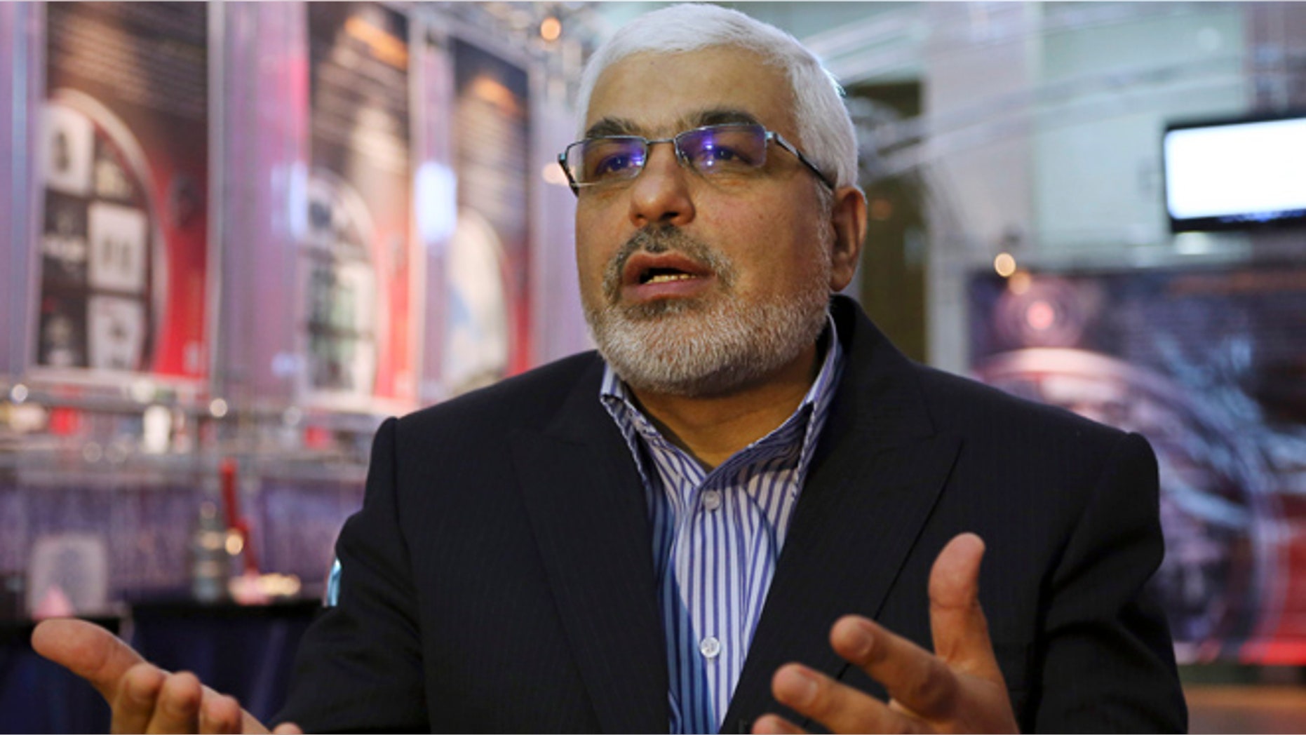 Sept. 1, 2014: Deputy head of the Atomic Energy Organization of Iran Asghar Zarean speaks in an interview with Associated Press as he is seated in a display of various parts and equipment from valves and pumps to electro motors, modems and barometers that they say were exported to the country with alleged purpose of sabotage and spying on Irans nuclear facilities in Tehran, Iran. (AP/Vahid Salemi)