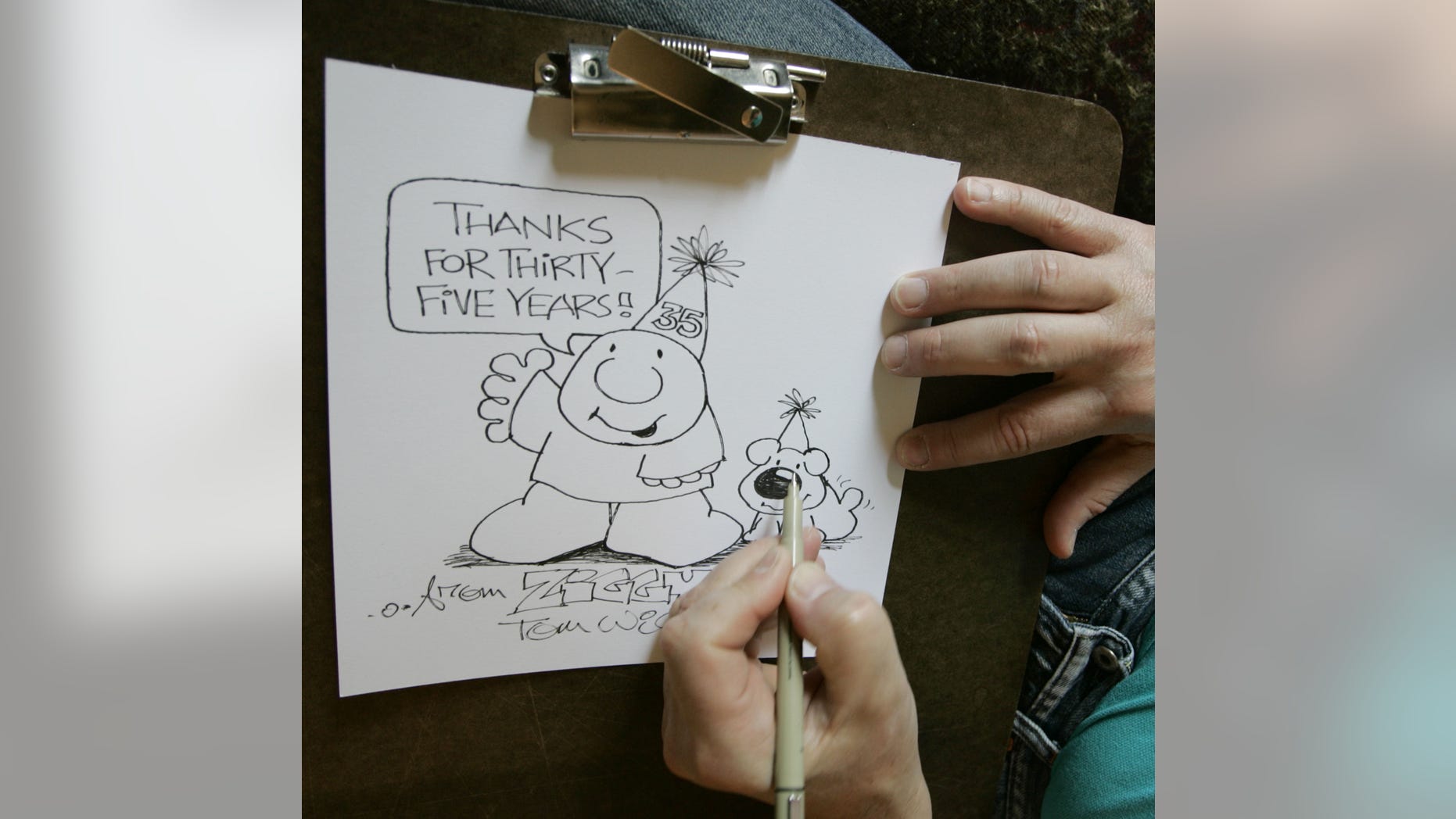 In this June 23, 2006 photo, Artist Tom Wilson Jr. draws a Ziggy cartoon celebrating the strip's 35th anniversary at his home in Loveland, Ohio. Tom Wilson Sr, the creator of hard-luck comic strip character Ziggy has died, he was 80. Spokesman Josh Peres with Universal Uclick, the Kansas City, Missouri, syndication company formerly known as Universal Press Syndicate, says Wilson Sr. died Friday, Sept. 16, 2011 after a long illness. Wilson's son, Tom Wilson Jr., who has produced the panel since 1987, says his father died of pneumonia at a Cincinnati hospital.