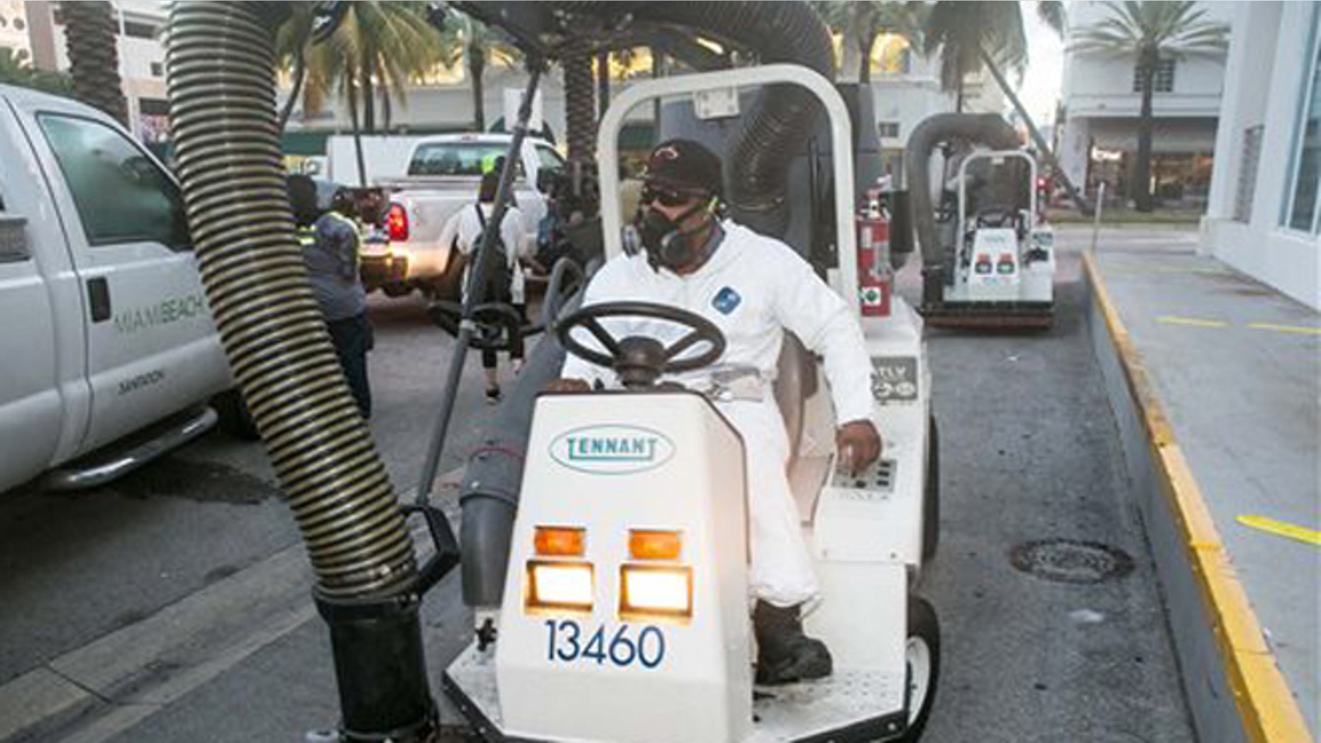 A City of Miami Beach Sanitation worker gets ready to clean the alleyways of South Beach, sucking up still waters and debris with a mobile vacuum, Friday, Aug. 19, 2016, Miami Beach, Fla., as part of the city's Zika clean-up. (C.M. Guerrero/El Nuevo Herald via AP)