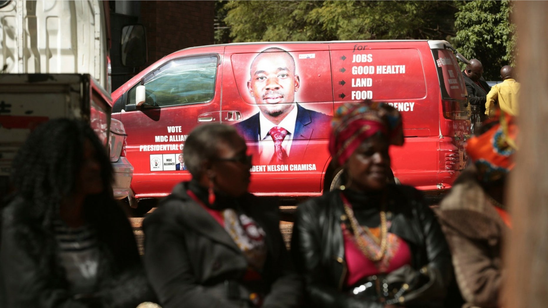 Supporters of Zimbabwes main oppositon leader, Nelson Chamisa are seen close to his campaign vehicle outside the magistrates courts in Harare, Thursday, June, 14, 2018.