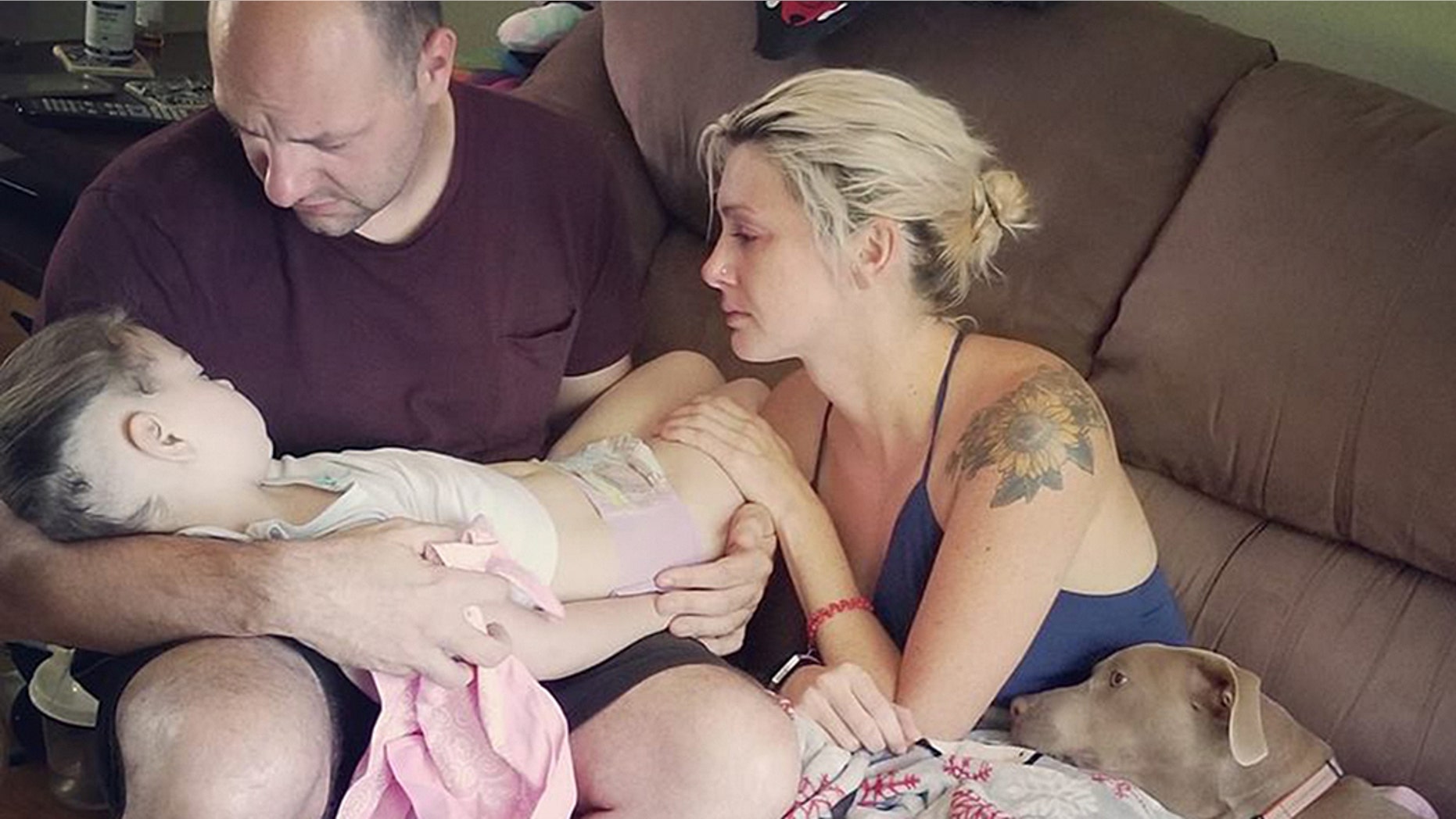 Ben and Casey Daggett hold their daughter Zoey in their arms just hours before she passed away.