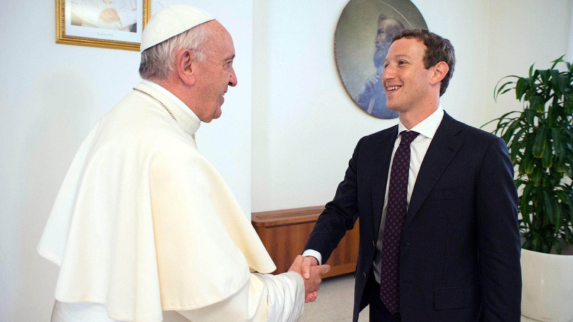 Pope Francis meets Facebook founder and CEO Mark Zuckerberg, at the Santa Marta residence, the guest house in Vatican City where the pope lives, Monday, Aug. 29, 2016. (L'Osservatore Romano/Pool Photo via AP)