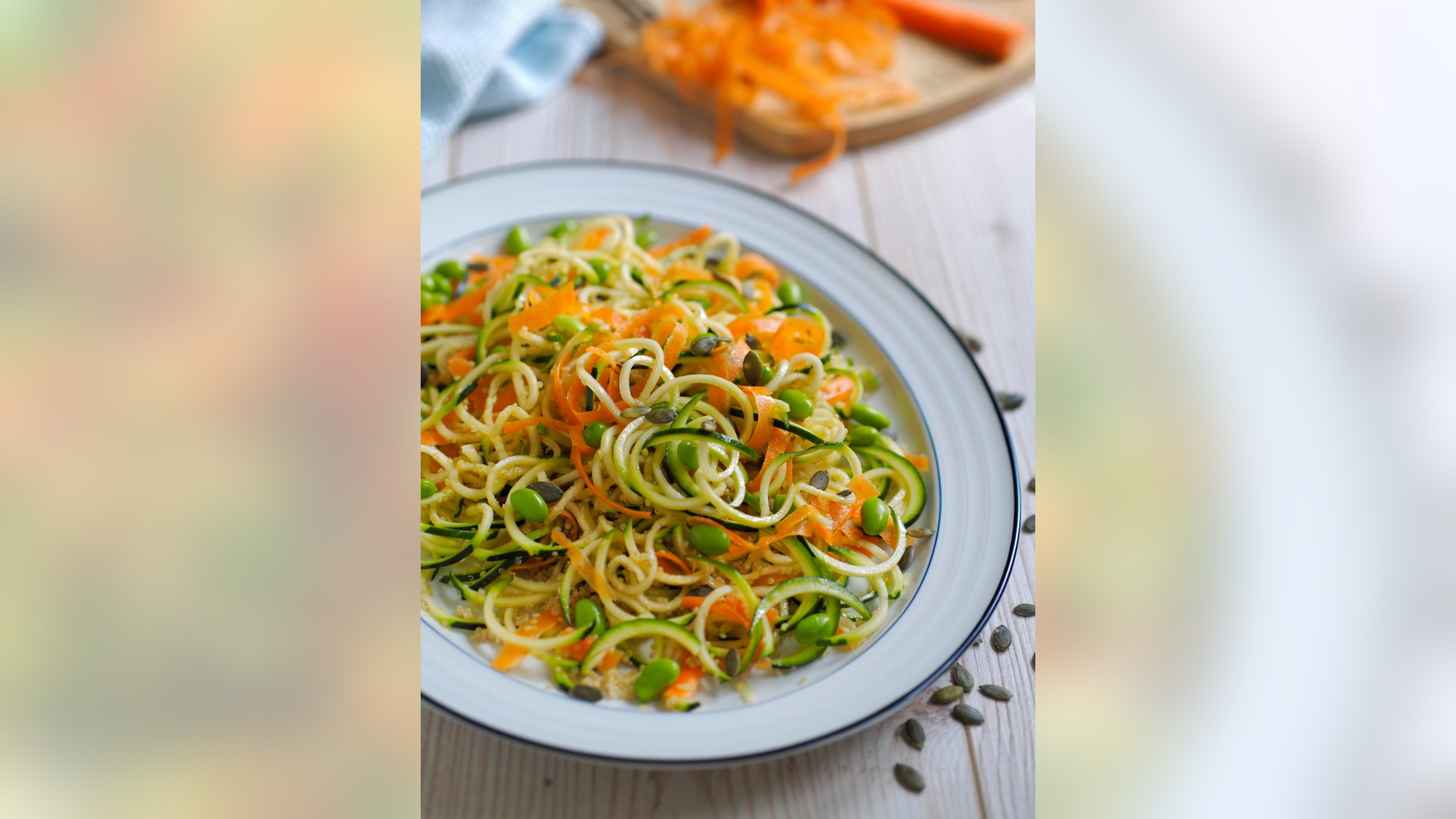 Home made frshness vegetarian noodles salad,made by courgette,carrot,and edamame beans and quiona,pumpkin seeds.