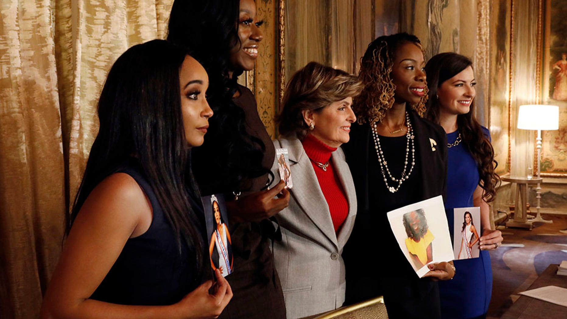 The four contestants in this year's Mrs. America pageant are calling for an apology from the pageant's owner over accusations he used racial slurs and stereotypes in a conversation, pose for photos, in New York, Monday, Oct. 15, 2018. They are, from left: Mrs. Delaware America Kimberly Phillips, Mrs. New Jersey America Crissy Timpson, attorney Gloria Allred, Mrs. Missouri Brandy Palacios, and Mrs. Ohio America Jeri Ward.