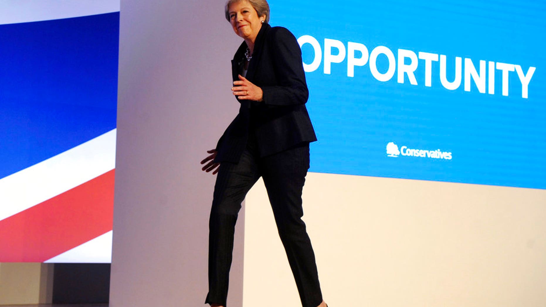 Conservative Party Leader and Prime Minister Theresa May dances as she arrives on stage to address delegates during a speech at the Conservative Party Conference at the ICC, in Birmingham, England, Wednesday, Oct. 3