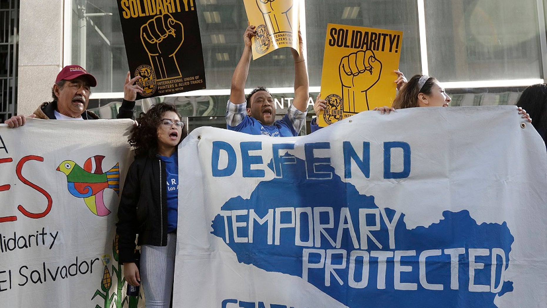 FILE: Supporters of temporary protected status immigrants before a news conference announcing a lawsuit against the Trump administration over its decision to end a program that lets immigrants live and work legally in the U.S.