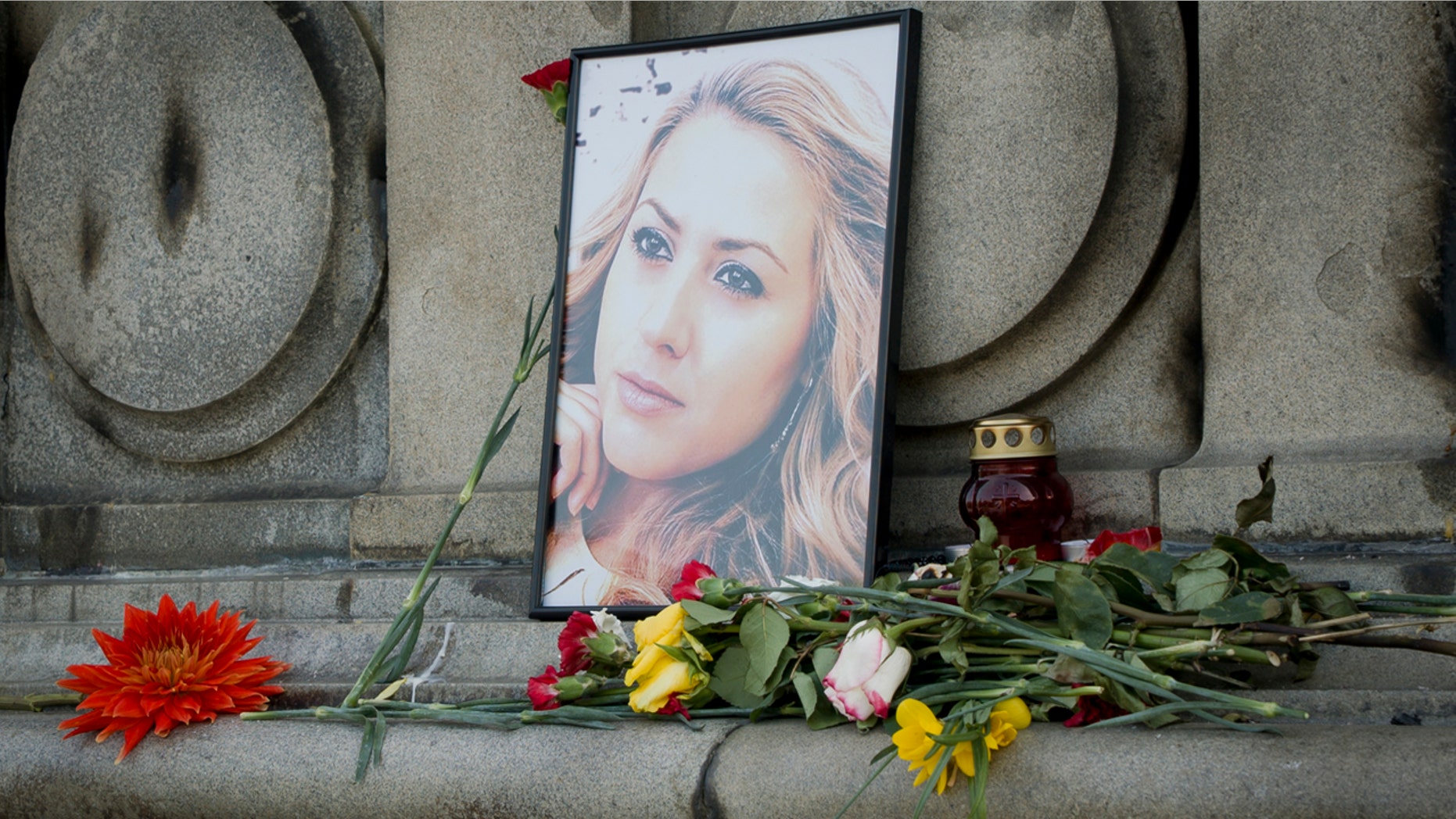 The photo of Viktoria Marinova, the journalist who was raped and strangled on Saturday, is placed on the Liberty Monument in Ruse, Bulgaria.