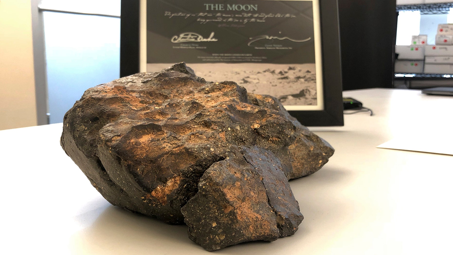 A 12-pound lunar meteorite found in northwestern Africa in 2017 rests on a table in Amherst, N.H.