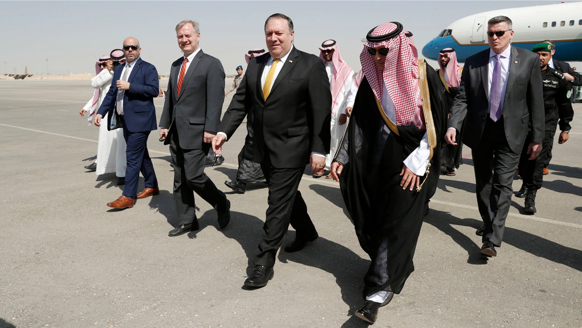 U.S. Secretary of State Mike Pompeo, second right in front, walks with Saudi Foreign Minister Adel al-Jubeir after arriving in Riyadh, Saudi Arabia, Tuesday, Oct. 16, 2018.