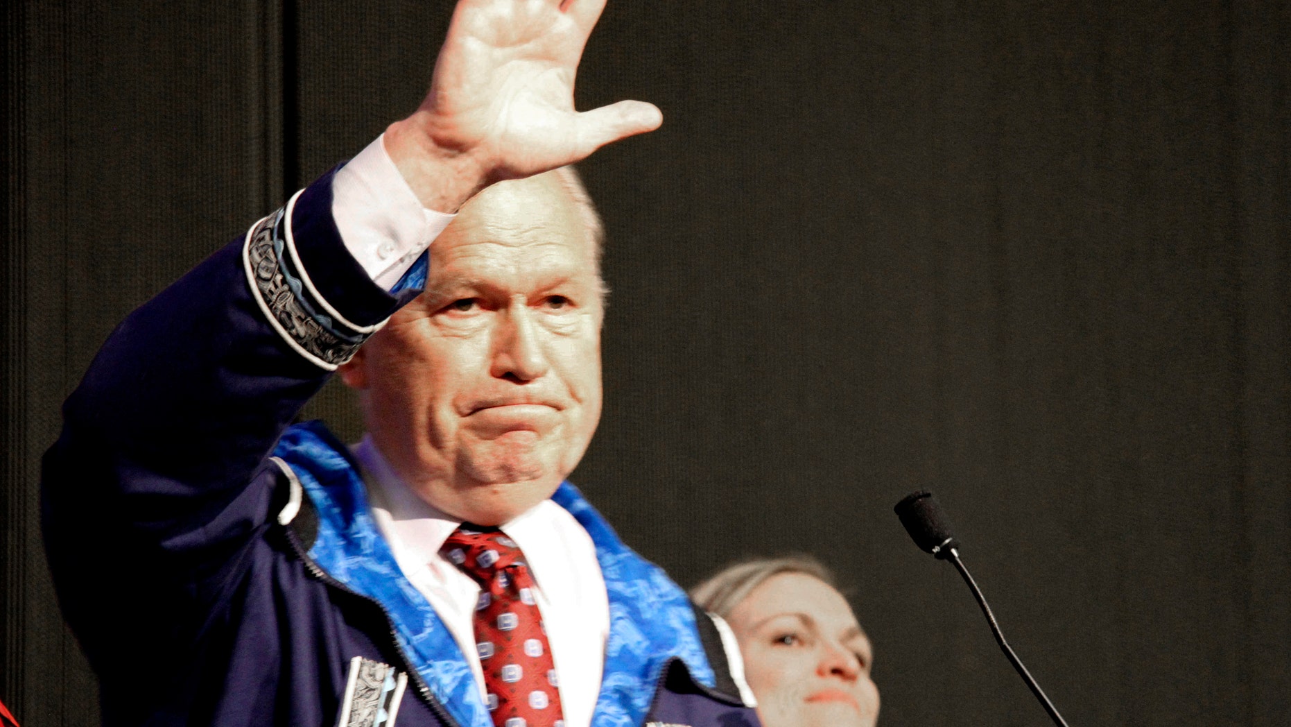 Alaska Gov. Bill Walker waves as he announces he will drop his re-election bid while addressing the Alaska Federation of Natives conference Friday, Oct. 19, 2018, in Anchorage. Walker's re-election plans were dealt a blow earlier in the week after his running mate, Lt. Gov. Byron Mallott, resigned after making an inappropriate overture toward a woman.