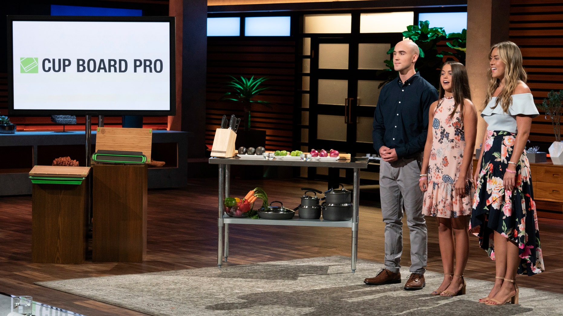 In this image provided by ABC, Kevin Young’s children present the product of their late father, Cup Board Pro, which is a chopping block that features a detachable bowl for clean up, on a "Shark Tank" episode that aired on Sunday, Oct. 21, 2018.