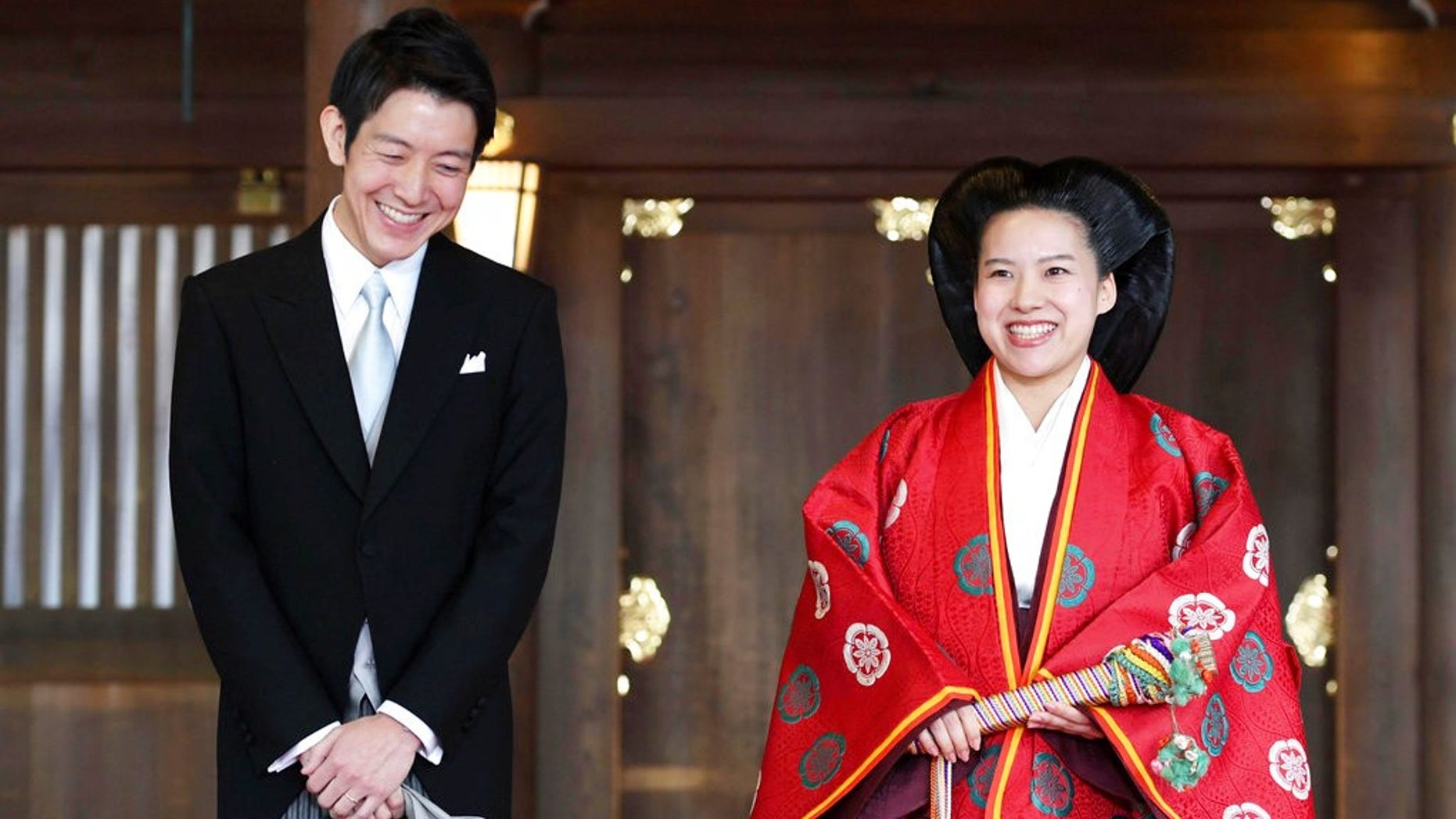 Japanese Princess Ayako, right, dressed in traditional ceremonial robe, and groom Kei Moriya, left, speak to the reporters after their wedding ceremony at Meiji Shrine in Tokyo, Monday, Oct. 29, 2018. Japan's Princess Ayako, the daughter of the emperor's cousin, has married Moriya, a commoner in a ritual-filled ceremony at Tokyo's Meiji Shrine.(Kyodo News via AP)