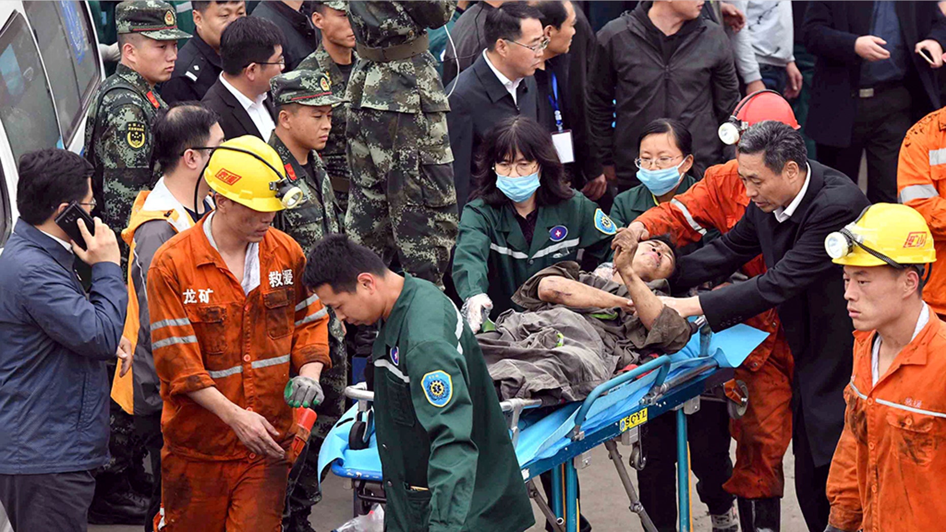 A worker is carried on a stretcher out of the Longyun coal mine in Yuncheng County, east China's Shandong Province, Sunday. (Guo Xulei/Xinhua via AP)