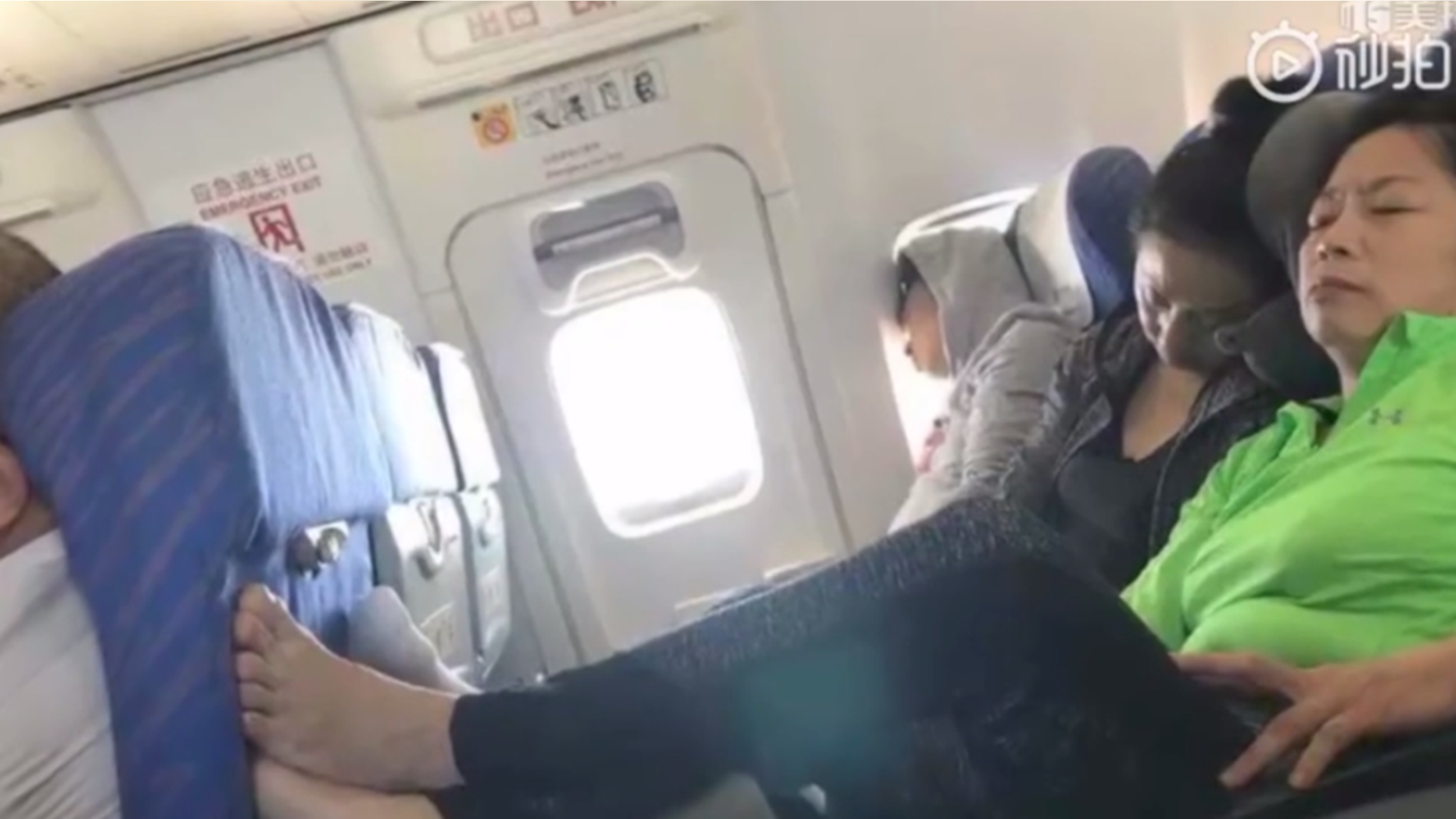 One woman travelling on a plane in China put her feet up on tray table and then refused to take them back down.