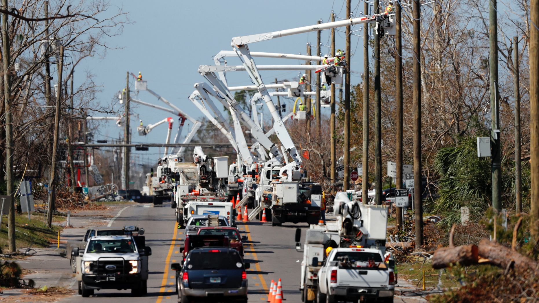 In this Thursday, Oct. 18, 2018 photo, utility crews set up new poles and utility wires in the aftermath of Hurricane Michael in Panama City, Fla. It's the greatest need after a hurricane and sometimes the hardest one to fulfill: Electricity. More than a week after Hurricane Michael smashed into the Florida Panhandle on a path of destruction that led all the way to the Georgia border, more than 100,000 Florida customers were still without power, according to the state Department of Emergency Management website. (AP Photo/Gerald Herbert)