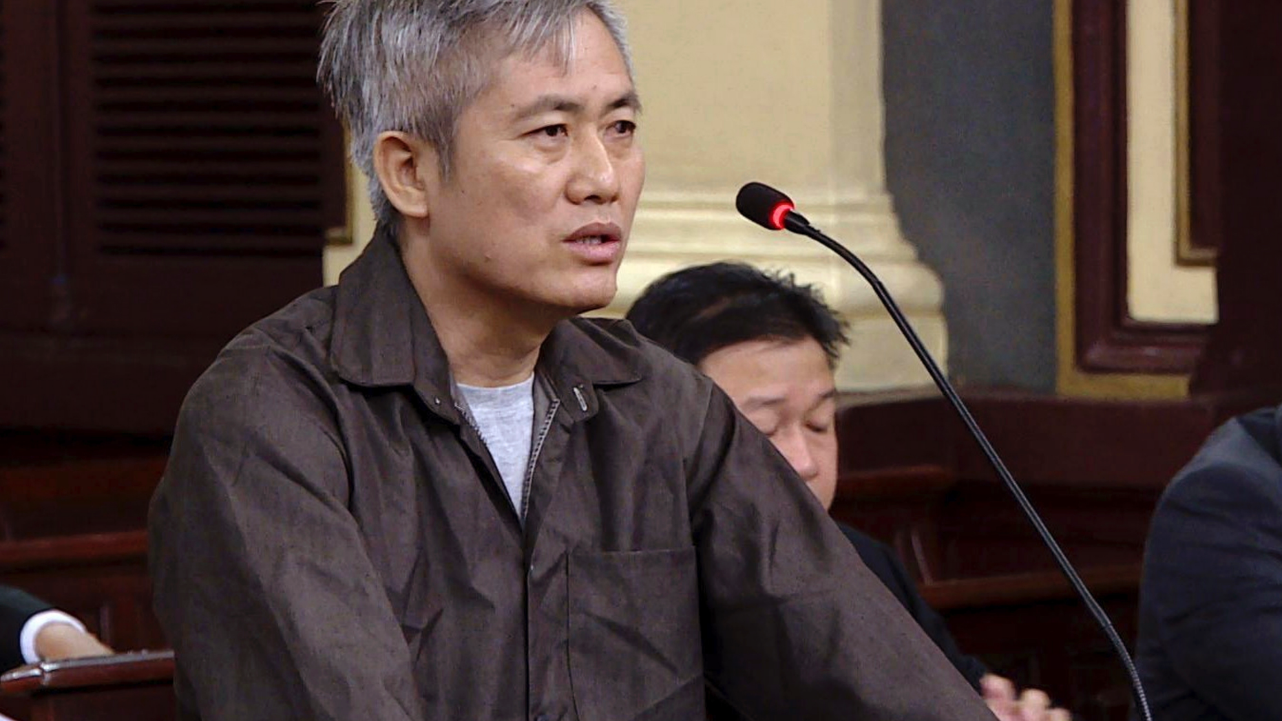 Luu Van Vinh stands trial in Ho Chi Minh City, Vietnam, Friday, Oct. 5, 2018. Vinh and four others were sentenced between eight to 15 years in prison for attempting to overthrow the government. (Thanh Chung/Vietnam News Agency via AP)