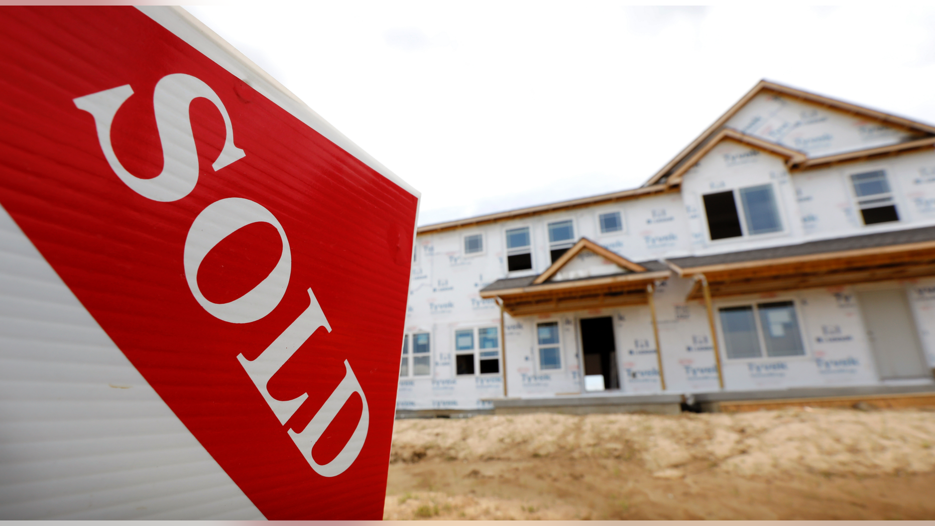 FILE- In this June 27, 2018, file photo, a sold sign stands in front of a home under construction in West Des Moines, Iowa. On Wednesday, Oct. 24, the Commerce Department reports on sales of new homes in September. (AP Photo/Charlie Neibergall, File)