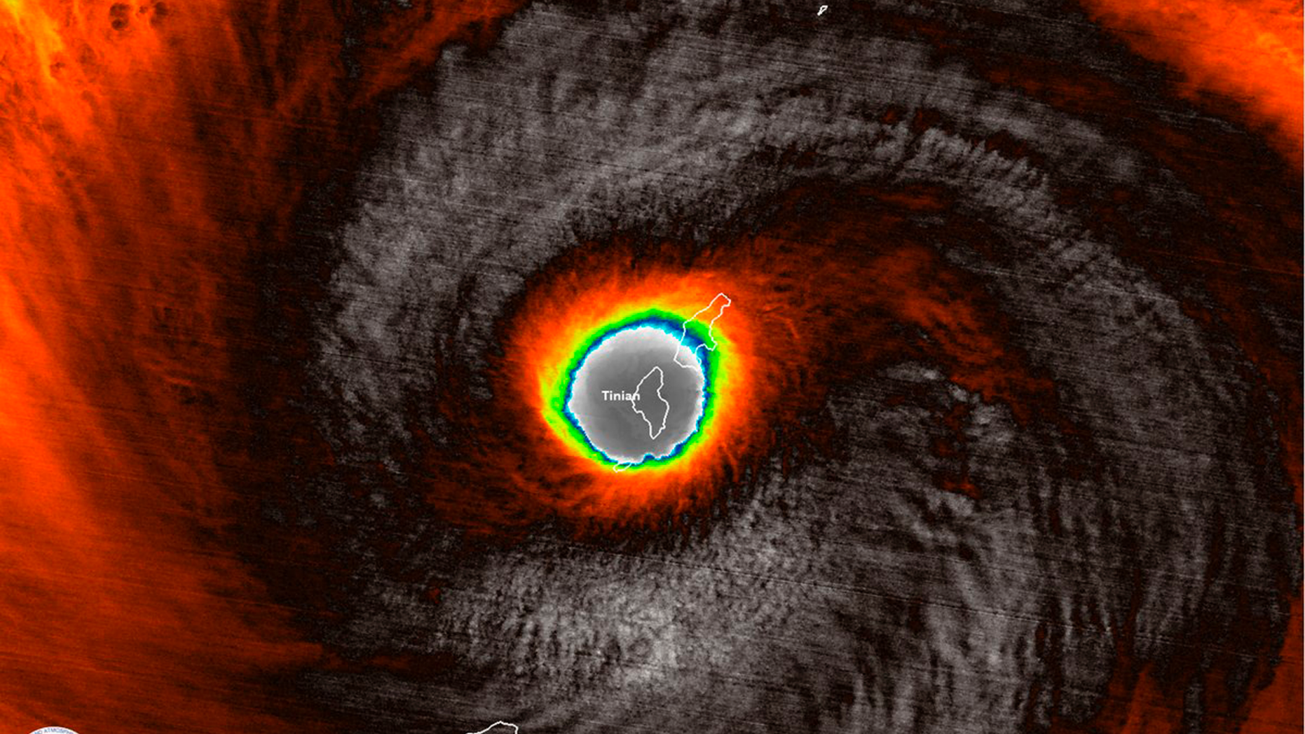 This false-color satellite image provided by the National Oceanic and Atmospheric Administration (NOAA) shows the moment the eye of Super Typhoon Yutu passed over Tinian, one of three main islands in the U.S. Commonwealth of the Northern Mariana Islands, producing damaging winds and high surf Wednesday, Oct. 24, 2018. The National Weather Service in Honolulu says maximum sustained winds of 180 mph (290 kph) were recorded around the eye of the storm, which passed over Tinian island and Saipan early Thursday morning local time. Waves of 25 to 40 feet (6 to 12 meters) are expected around the eye of the storm. (NOAA via AP)