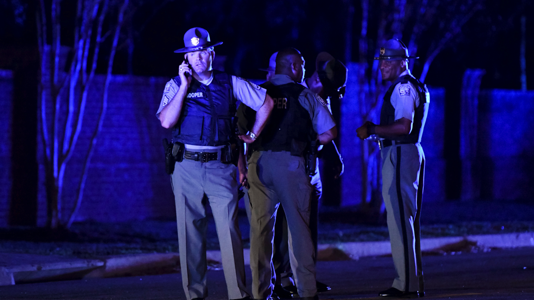 South Carolina state troopers gather on Hoffmeyer Road near the Vintage Place neighborhood where several law enforcement officers were shot, one fatally, Wednesday, Oct. 3, 2018, in Florence, S.C. (AP Photo/Sean Rayford)
