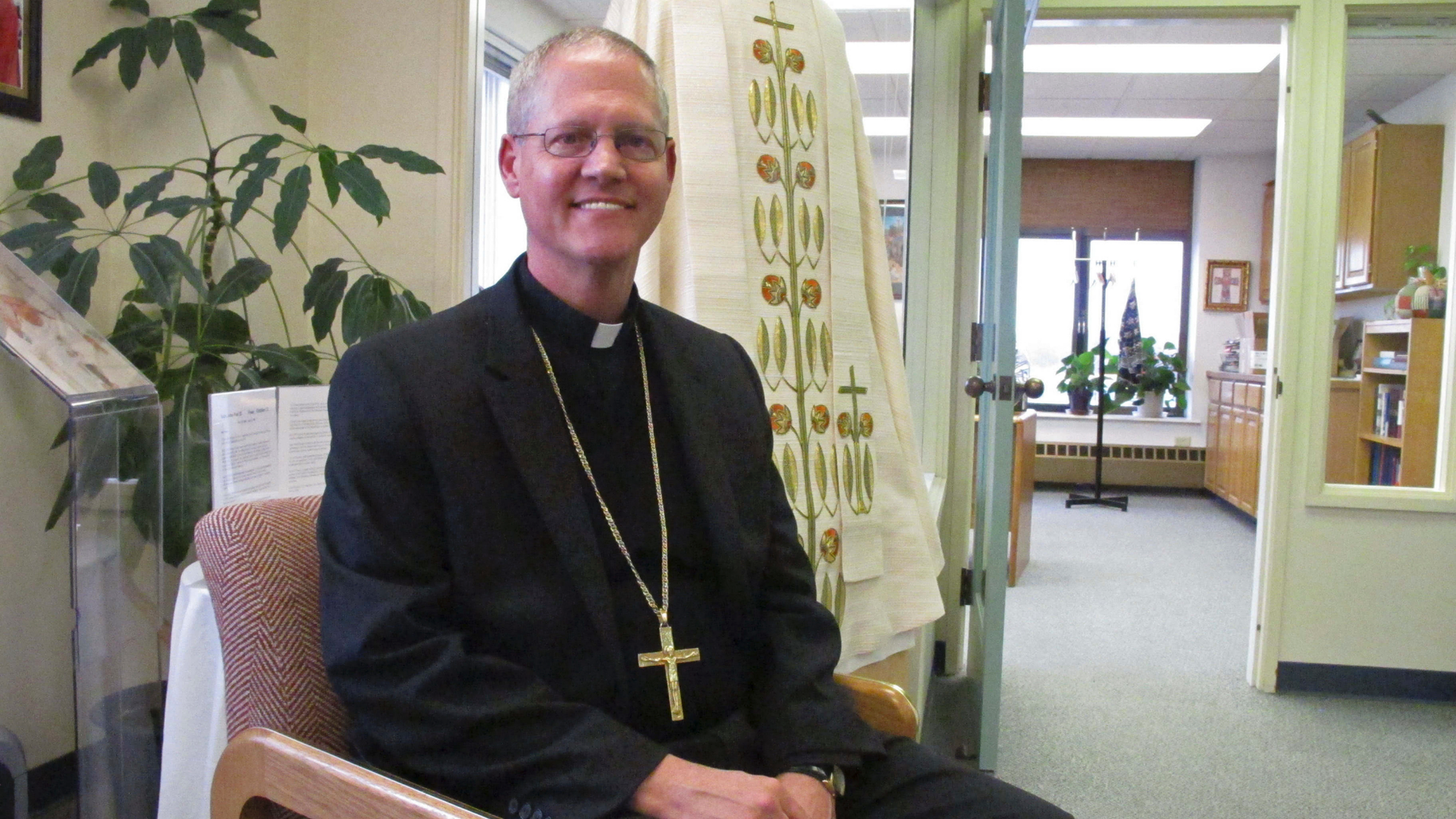 Catholic Archbishop Paul Etienne is shown Wednesday, Oct. 24, 2018, at his office in Anchorage, Alaska. Etienne said the Anchorage Archdiocese has ordered an independent review of sexual abuse claims by reviewing the files of priests and others associated with the archdiocese since it was established in 1966. (AP Photo/Rachel D'Oro)