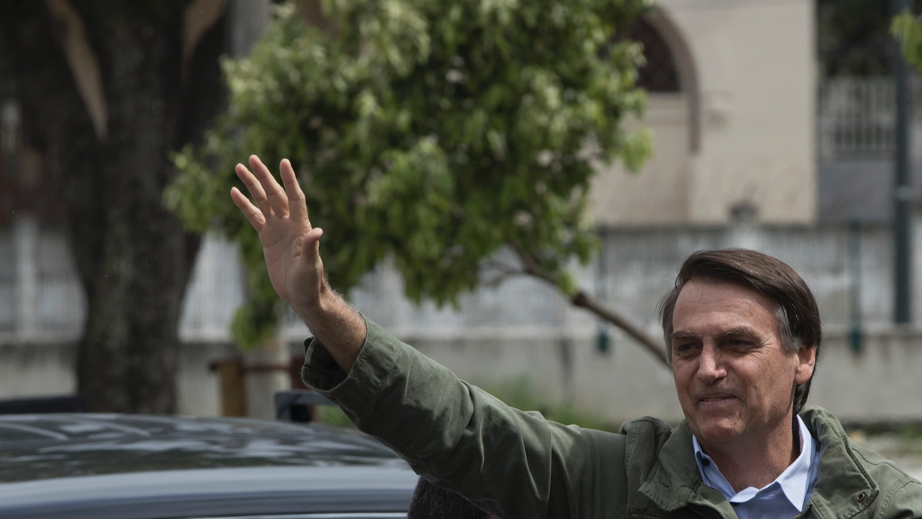 Presidential candidate Jair Bolsonaro, of the far-right Social Liberal Party waves to supporters after voting at a polling station in Rio de Janeiro, Brazil, Sunday, Oct. 28, 2018. Bolsonaro is running against leftist candidate Fernando Haddad of the Workers' Party. (AP Photo/Leo Correa)