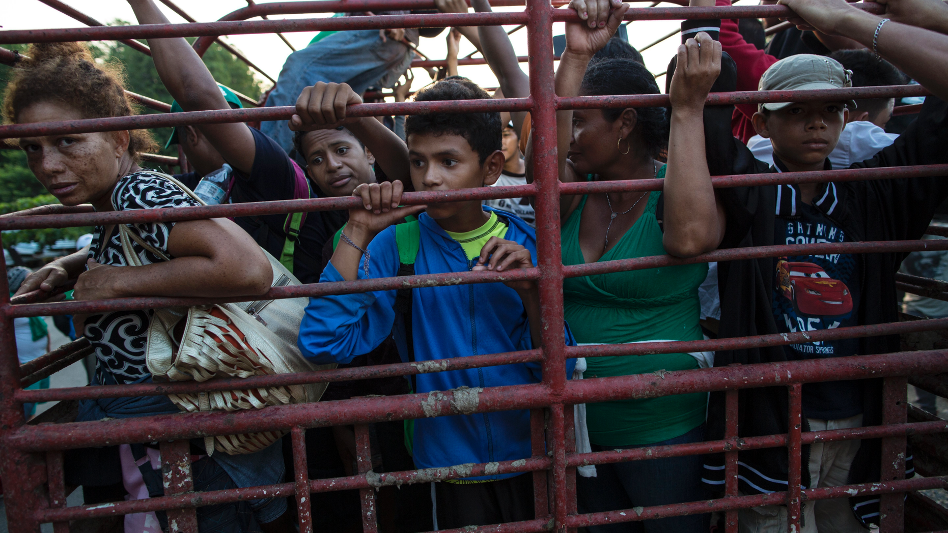 Migrants travel on a cattle truck, as a thousands-strong caravan of Central American migrants slowly makes its way toward the U.S. border, between Pijijiapan and Arriaga, Mexico, Friday, Oct. 26, 2018. Many migrants said they felt safer traveling and sleeping with several thousand strangers in unknown towns than hiring a smuggler or trying to make the trip alone. (AP Photo/Rodrigo Abd)