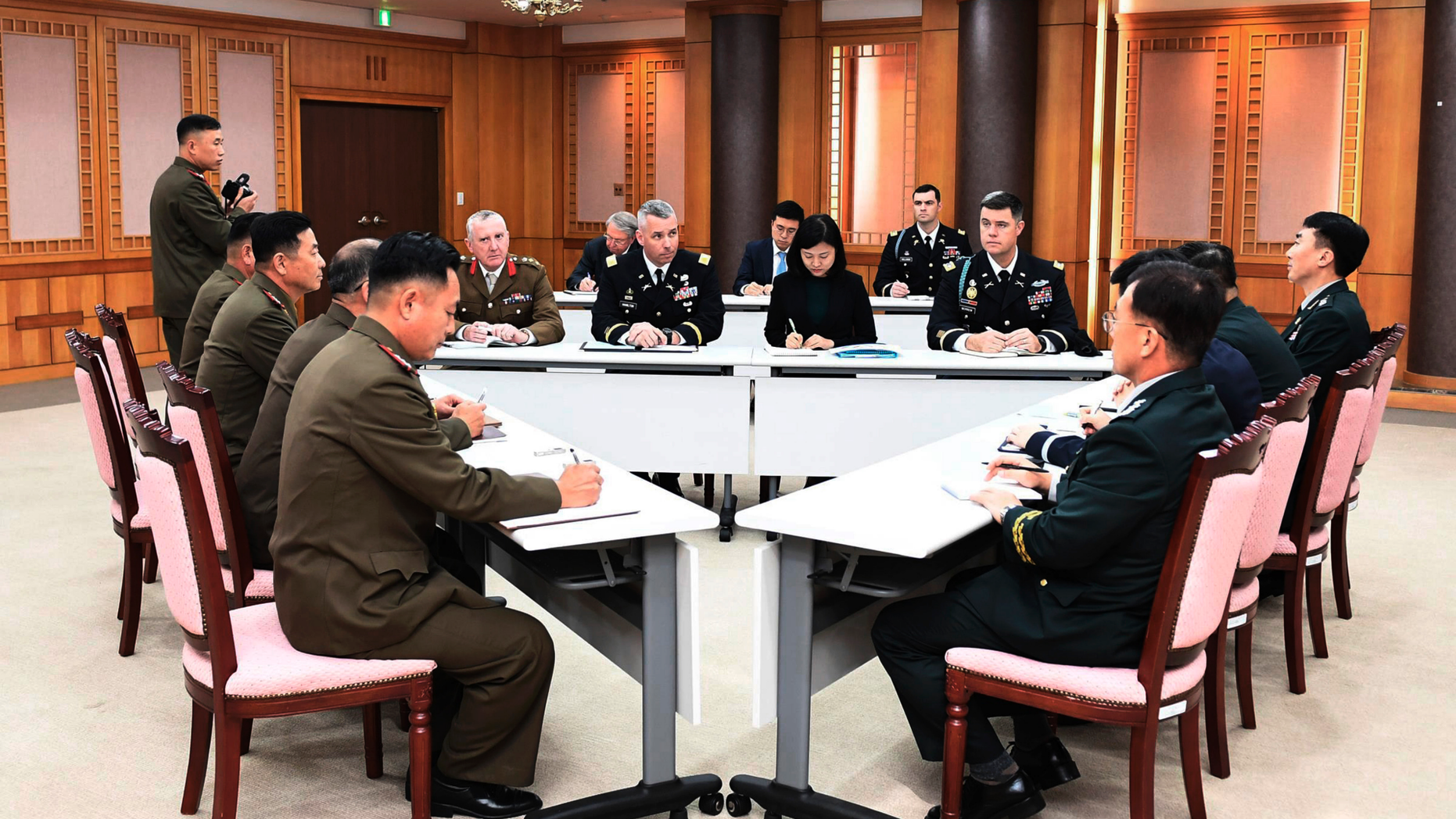 FILE - In this Oct. 16, 2018, file photo provided by South Korea Defense Ministry, the U.S.-led United Nations Command, center, South Korean and North Korean, left, military officers attend a meeting at the southern side of Panmunjom in the Demilitarized Zone, South Korea. The two Koreas and the U.S.-led U.N. Command on Monday, Oct. 22, 2018, are meeting again at the Koreas' border village to examine an ongoing effort to disarm the area. (South Korea Defense Ministry via AP, File)
