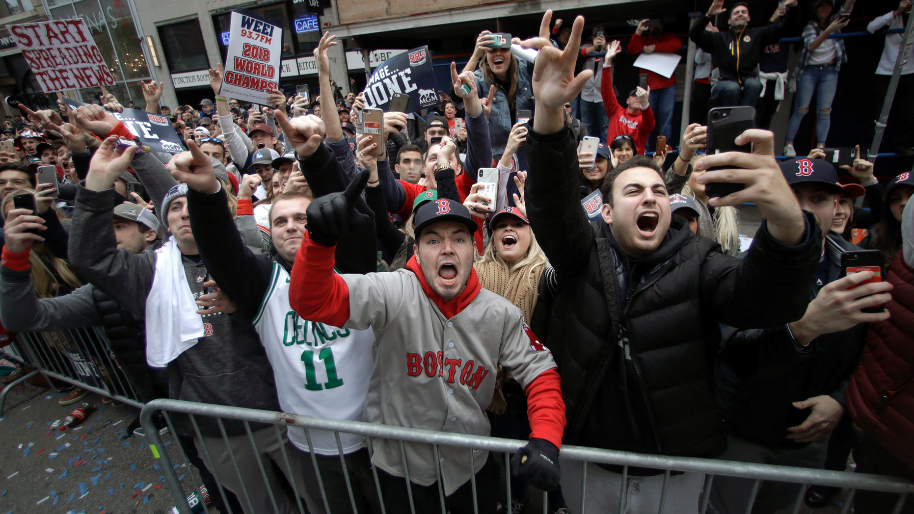 Boston Red Sox fans cheer during a parade to celebrate the team's World Series championship over the Los Angeles Dodgers, Wednesday, Oct. 31, 2018, in Boston. (AP Photo/Charles Krupa)