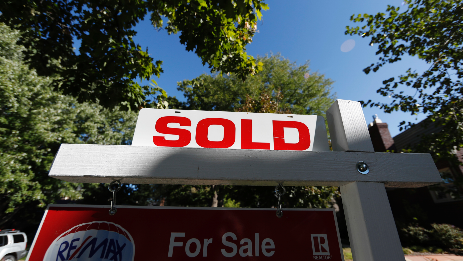 FILE- In this Thursday, Aug. 30, 2018, photo a sale placard tops a sale sign stand outside a home on the market in Denver. The National Association of Realtors serves up its latest monthly tally of home sales Friday, Oct. 19. (AP Photo/David Zalubowski, File)