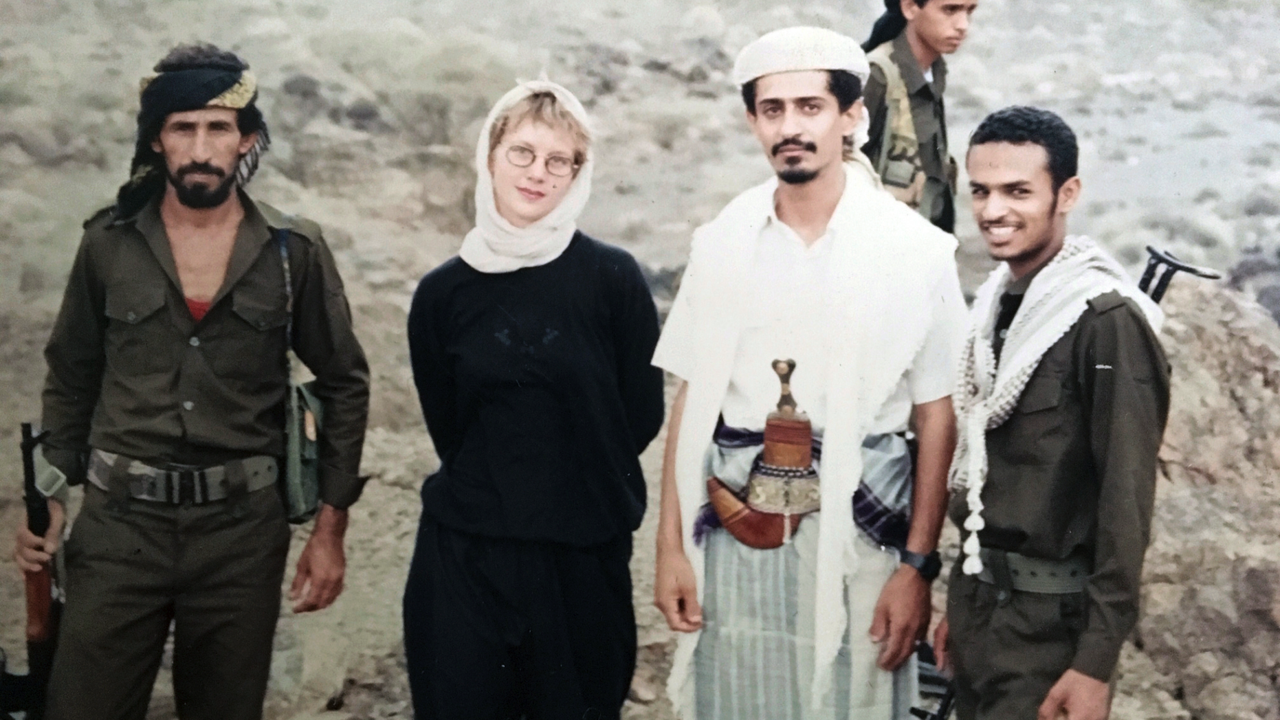 This 1994 photo provided by Katherine Roth shows her standing with Yemeni fighters. The photo was taken by Jamal Khashoggi in Yemen after the country’s civil war. Khashoggi was Roth’s friend and mentor when she was a young reporter on a fellowship studying Islamic movements. (Jamal Khashoggi/Courtesy of Katherine Roth via AP)