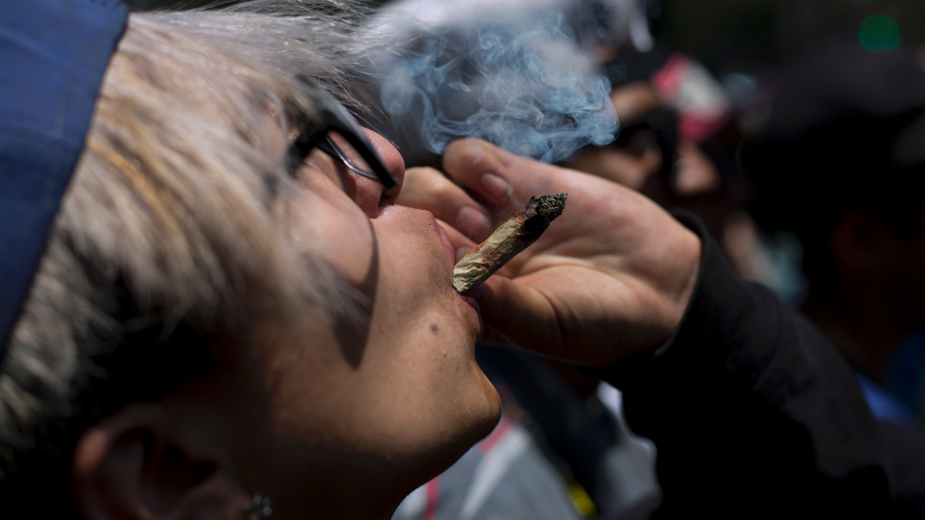FILE - In this April 20, 2018 file photo, a young man smokes marijuana to celebrate the International Day for Cannabis in Mexico City. Mexico’s Supreme Court issued two more rulings Wednesday, Oct. 31, ordering that complainants in individual cases be allowed to use marijuana for recreational purposes, establishing a precedent which will apply for others that a blanket prohibition is unconstitutional. (AP Photo/Eduardo Verdugo, File)