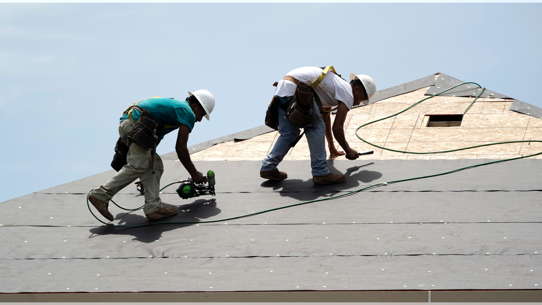 FILE- In this July 23, 2018, file photo construction workers put down roofing paper on home in Houston. General contractors and other small businesses in the home remodeling industry can expect revenue to slow in 2019, the result of rising mortgage rates and sluggish home sales. That's the prediction of Harvard University's Joint Center for Housing Studies, which last week issued its quarterly report on home remodeling. (AP Photo/David J. Phillip, File)
