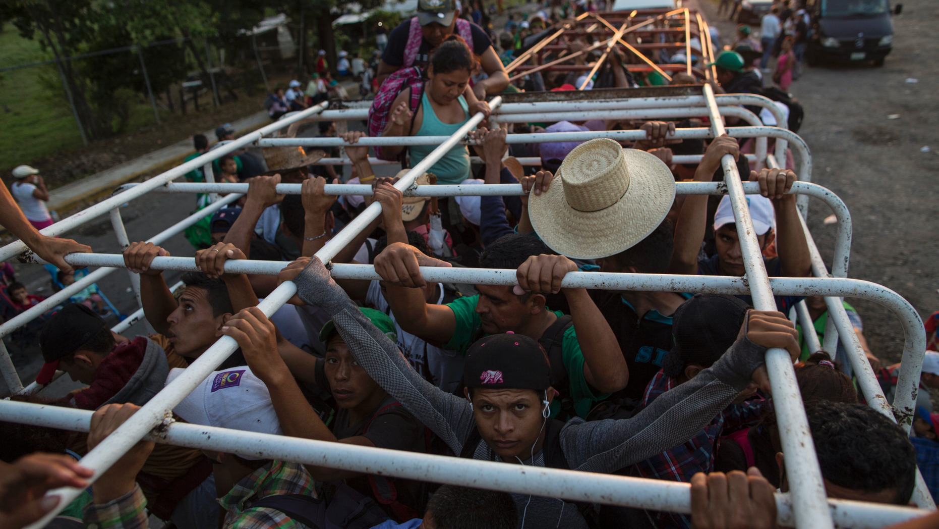 Migrants travel on a cattle truck, as a thousands-strong caravan of Central American migrants slowly makes its way toward the U.S. border, between Pijijiapan and Arriaga, Mexico, Friday, Oct. 26, 2018. Many migrants said they felt safer traveling and sleeping with several thousand strangers in unknown towns than hiring a smuggler or trying to make the trip alone. (AP Photo/Rodrigo Abd)